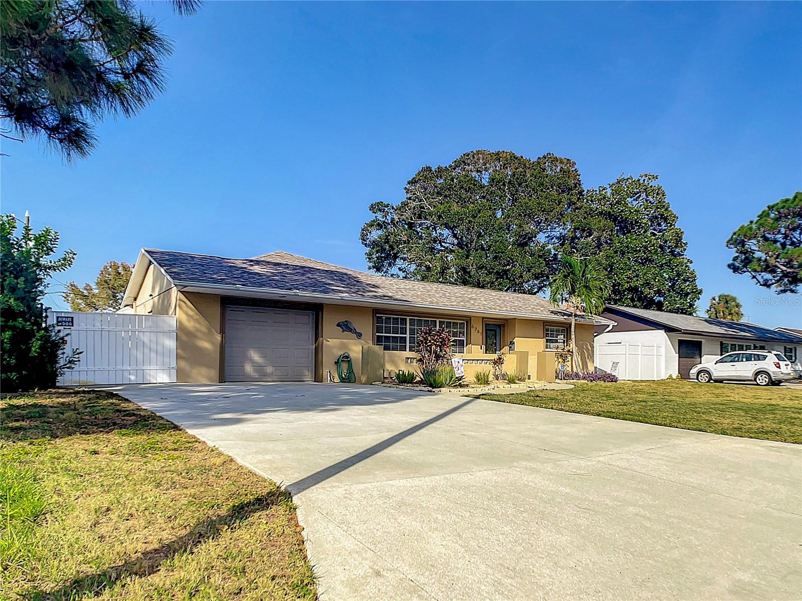 A perfect location! Welcome to this spacious and updated three-bedroom, two-bath, screened pool home, located on a quiet street in a fantastic neighborhood.  This home has an open floor plan, with a newly remodeled kitchen and appliances. This split-bedroom home offers a perfect layout for entertaining with stainless steel appliances, and beautiful wood cabinets with granite countertops. In addition, there is a wet bar with dual wine refrigerators. All bedrooms have built-in closet systems. 
There is a large dining room with a bonus room you could use as a den, a man cave, or an office. The master bedroom has a spacious stand-up shower and jacuzzi tub. There is a one-car garage with room for plenty of storage. There are beautiful French doors with built-in blinds that lead to the beautiful pool area. There is a screen-enclosed pool with a brick paver patio with a privacy fence. Enjoy the spill-over jacuzzi to the pool with a sun shelf. Pool was completely redone with new gunite and added tiles with a sunshelf and new hand rails. There is lush landscaping with an irrigation system. In addition, there is a concrete pad for boat parking. 
A new roof was in 2019 and a new a/c was in 2020. This is a prime location, just minutes to the most beautiful Gulf Beaches! In addition, you are close to many shopping and dining options. Easy access to downtown St. Petersburg.  
Start living your life in St Petersburg today! This opportunity won’t last!