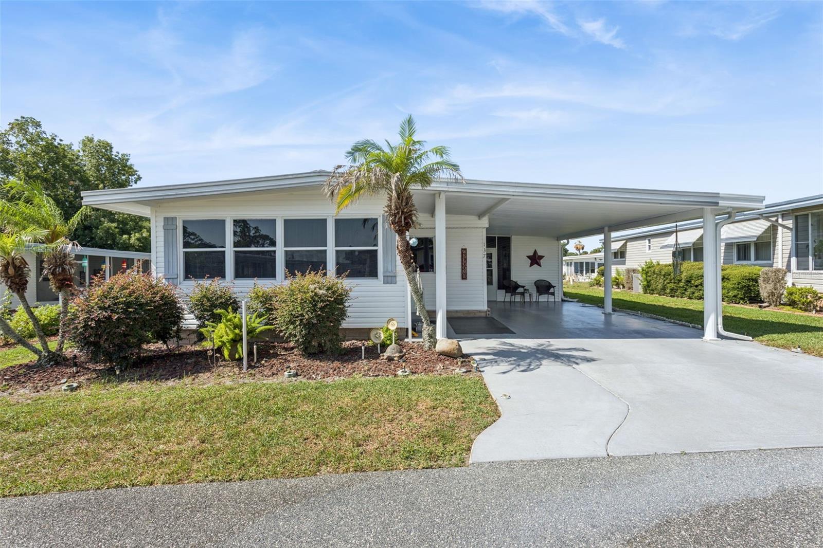 Welcome home to this beautifully maintained 2-bedroom, 2-bath residence in the highly sought-after gated 55+ community of Hawthorne at Leesburg. Situated along the western shore of Lake Harris and connected to the lake by a canal, Hawthorne offers an exceptional waterfront lifestyle with a marina featuring covered and uncovered boat slips available for lease as space permits. This move-in-ready home is being sold completely furnished, with the seller only taking a lift chair and personal belongings. Inside, you'll find a spacious dining area adjoining the kitchen, complete with a convenient breakfast bar. The comfortable living room features a newer electric fireplace and a 65-inch television, creating the perfect space for relaxing or entertaining. Stretching across the front of the home is a bright and inviting bonus room filled with natural light from numerous windows, making it ideal for a home office, craft room, or library. The primary bedroom includes an en-suite bath for added privacy and comfort. The attached Florida room offers even more functional space, including a laundry room with a new washer and dryer and a workshop stocked with a variety of tools. Two exterior storage units provide additional storage solutions. Residents of Hawthorne enjoy an impressive array of amenities, including an outdoor geothermal-heated swimming pool, two enclosed therapeutic pools, saunas, bocce courts, shuffleboard, pickleball, tennis courts, billiards, card rooms, and a full calendar of activities highlighted by the popular Hawthorne Concert Series. For added peace of mind, three emergency response vehicles are available to residents 24 hours a day, 7 days a week. Experience the active Florida lifestyle in this vibrant and welcoming community—schedule your private tour today!