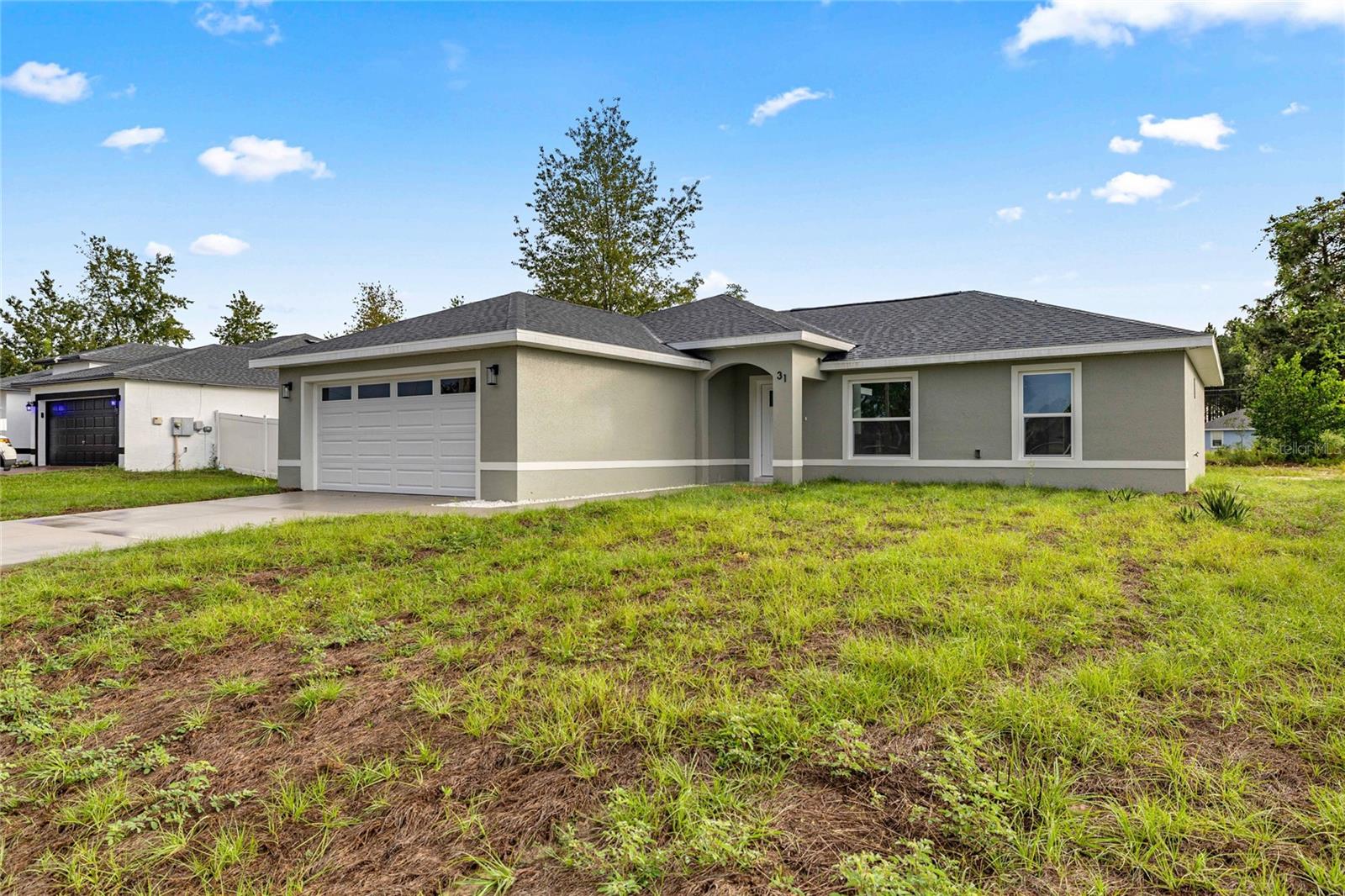 Under Construction. 0.24-acre homesite • Pella Defender impact-resistant windows • Oversized 2-car garage • No HOA

UNDER CONSTRUCTION – Estimated Completion: End of July 2026! Be among the first to own this brand-new 3-bedroom, 2-bath home at 181 Pine Crse, Ocala, FL, located in the growing Silver Springs Shores community. Designed with a spacious open-concept layout, this home combines quality construction, premium finishes, and everyday functionality on a generous 0.24-acre homesite.

The kitchen features Calacatta Rocky Gold quartz countertops, custom cabinetry, a large center island with bar seating, and an open flow to the dining and living areas. Carpenter Ash porcelain wood-look tile flooring extends throughout the home for durability and low maintenance.

The owner's suite includes a walk-in closet and a private bath with dual vanities and an oversized walk-in shower finished with Whiteheaven Polished II 24"x48" porcelain tile. Every bathroom includes a window for natural light and ventilation.

Additional features include Pella Defender impact-resistant windows with laminated safety glass, reinforced vinyl frames, and an advanced auto-lock system, upgraded interior doors, modern black interior trim, a large indoor laundry room, energy-efficient construction, a covered rear lanai, and an oversized 2-car garage—a feature not commonly found in similarly sized new construction homes.

Conveniently located with access to shopping, restaurants, grocery stores, parks, schools, medical facilities, and major roadways, this home offers both comfort and convenience. Silver Springs Shores provides easy access to Maricamp Road (SR 464), Silver Springs State Park, Lake Diamond Golf & Country Club, and downtown Ocala.

Buyer Incentive: Buyers may receive up to 2% of the loan amount as a lender credit toward closing costs, prepaid expenses, or an interest rate buy-down when financing through the seller's preferred lender. Buyers may use any lender of their choice.

Please note: Photos shown are of a completed model home and are for illustrative purposes only. Colors, finishes, fixtures, and features may vary. Home is currently under construction with an estimated completion at the end of July 2026.