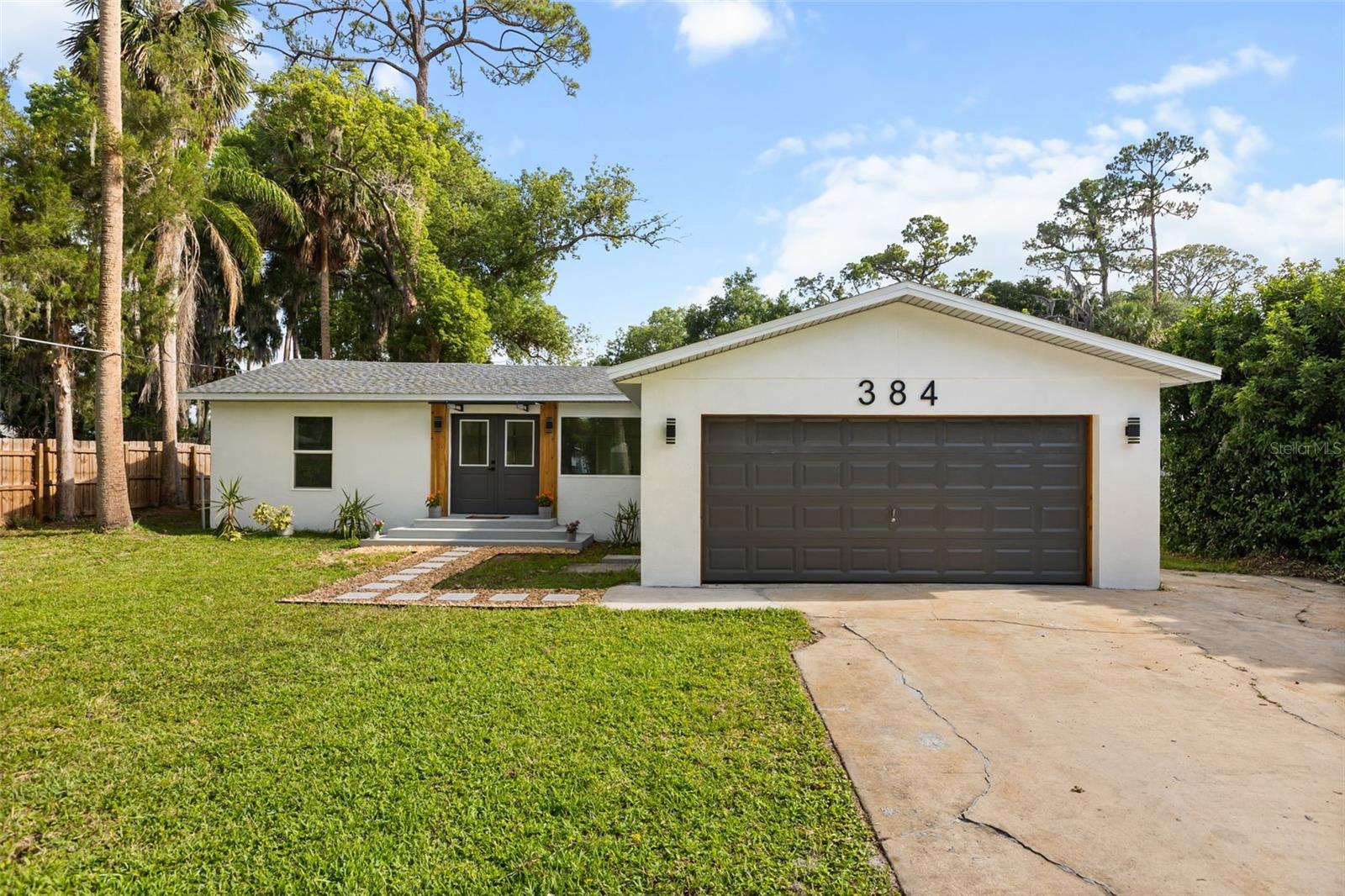 Don't miss your chance to own this 3-bedroom 2 bath beautifully remodeled home located in sought out neighborhood in Debary! The home features an office/den that could be used a possible 4th bedroom. You will be impressed with the size of the lot 75 x 210 with over a 1/3 of an acre so you can park your boat and RV. Step into this light-filled, modern kitchen featuring stunning quartz countertops, sleek new stainless steel appliances, warm wood cabinetry, and stylish matte black accents—all centered around a spacious island perfect for entertaining. As you walk through you will notice all the custom upgrades and attention to detail. Home offers popular open layout, split floor plan, impact resistant double pane windows, luxury vinyl plank, plenty of closet space and recessed LED lighting throughout. New roof 2024. Both bathrooms have recently been renovated from top to bottom. From the living room walk out to your open brick paver patio where you will enjoy every minute you get spending time with guest and family. Home recently painted inside and out. Home comes with all new appliances and a smart water heater. Conveniently located minutes to I-4 so you have easy access to all of Orlandos theme parks and major attractions. Shows like a model home, expect to be impressed!