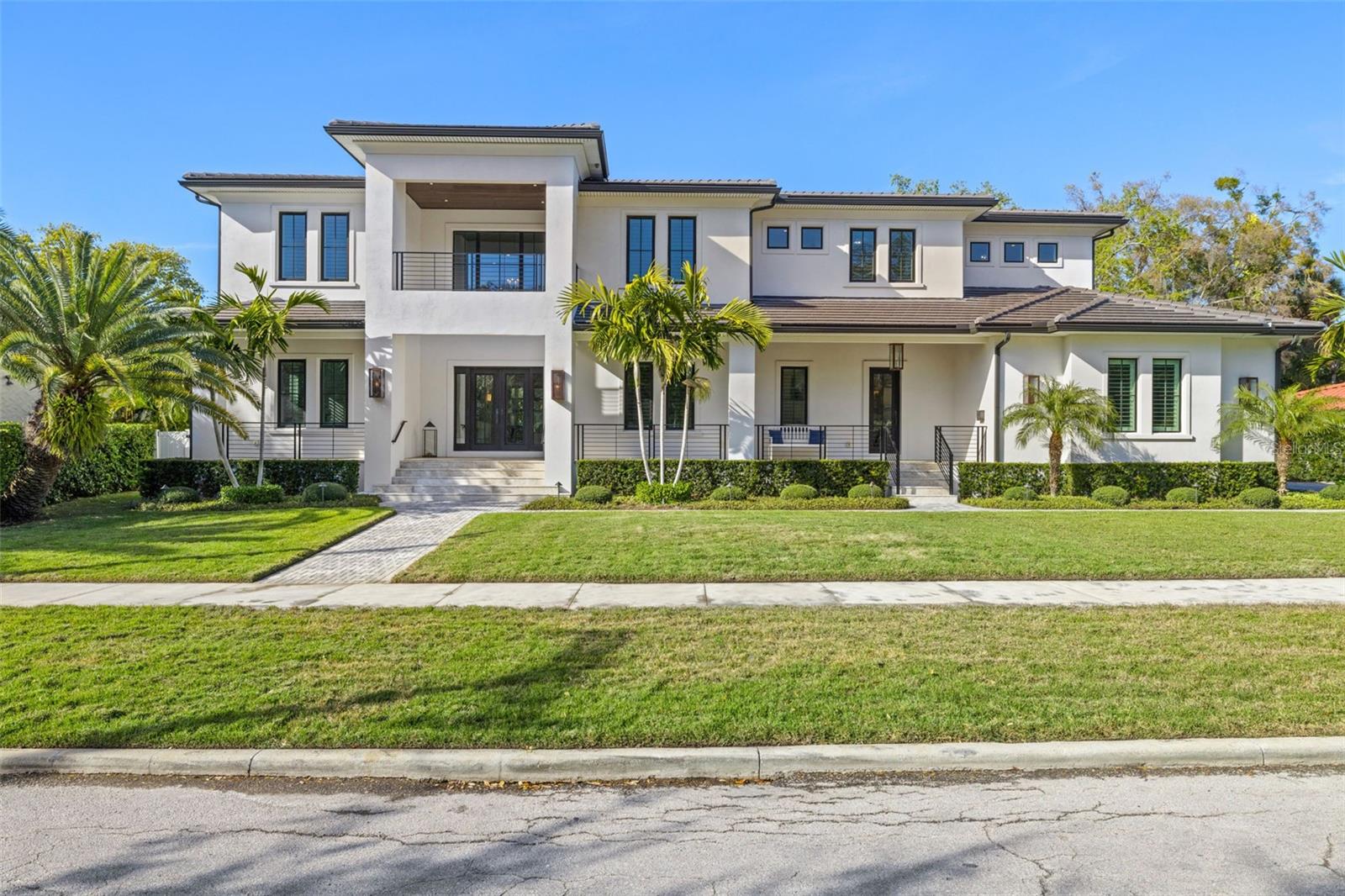Presenting an unparalleled custom estate, built in 2020 in Transitional Style, nestled within the highly coveted Beach Park neighborhood in South Tampa. This residence embodies a timeless, harmonious, and inviting elegance rarely seen. Thoughtfully designed without
 compromise, the collaborative vision of the owners, the esteemed builder's craftsmanship, and tasteful details converge to create this remarkable home. This two-story block estate spans 6,000 SF., offering 5 en-suite bedrooms (one transformed into a media room), 5 & 2 half baths, and 3-car side-entry garage. A striking first impression is made with its welcoming two-story front porch and terrace, adorned with travertine floors and gas coach lamps that cast a warm glow upon the exterior landscaped surroundings, paved walkways, and driveway. Immerse yourself in a realm of comfort and refinement, greeted by an elegant foyer, soaring ceilings, statement staircase, and front and center views of the outdoor oasis. The expansive layout effortlessly accommodates a formal dining room featuring a built-in buffet with two wine coolers, a secluded office space, social areas on the right wing, and a serene, private Mother-in-Law suite on the left. The gourmet kitchen is a dream for culinary enthusiasts, equipped with premium elements including a substantial island with wrapping cabinetry underneath, quartzite countertops, pot filler, double oven, 6-burner gas range, and professional-grade Thermador appliances. Adjacent, the breakfast nook offers ample space and direct access to the lanai. Discover the concealed butler's pantry, cleverly tucked away behind the kitchen, ideal for your catering staging needs and wine collection, with its separate service entrance and convenient mudroom. Exquisite upgrades throughout, such as tray and coffered ceilings, crown molding, expanded baseboards, superior plantation shutters, hardwood floors, stylish lighting fixtures and chandeliers, quartzite and marble countertops. The family room seamlessly blends spaciousness with coziness, featuring volume pocket sliding doors, fireplace, and peaceful views. Retreat to the expansive master suite boasting a luxurious bath with marble floors and waterfall edge countertops, Restoration Hardware lighting, oversized walk-in closet with wardrobe and accessories organization system and island. Three secondary bedrooms offer en-suite baths and walk-in closets with built-in organizers. The expansive upstairs game room has been converted into a fully functional home gym with a wet bar. The outdoor oasis includes a massive, covered lanai with travertine upper and lower decks, resort style pool and spa, lounge and dining spaces, fire pit, professional outdoor kitchen, and pool bath. You will appreciate the owners’ investment in lush, professional landscaping. The backyard displays artificial turf on the left side, where your pets can roam free while you host al fresco parties on the right side in the oversized garden, which is uncommon to find in South Tampa. Fenced-in for privacy and leisure activities. Additional amenities: upstairs laundry, storage, surround sound, state of the art Control-4 smart home technology and security system, water softener, full home generator, upgraded fire sensors. Slate tile roof for exceptional durability. Garage with finished epoxy floors and built-ins. Minutes from downtown, airport, beaches, cultural center, business district, dining, entertainment, and in top-rated school district.