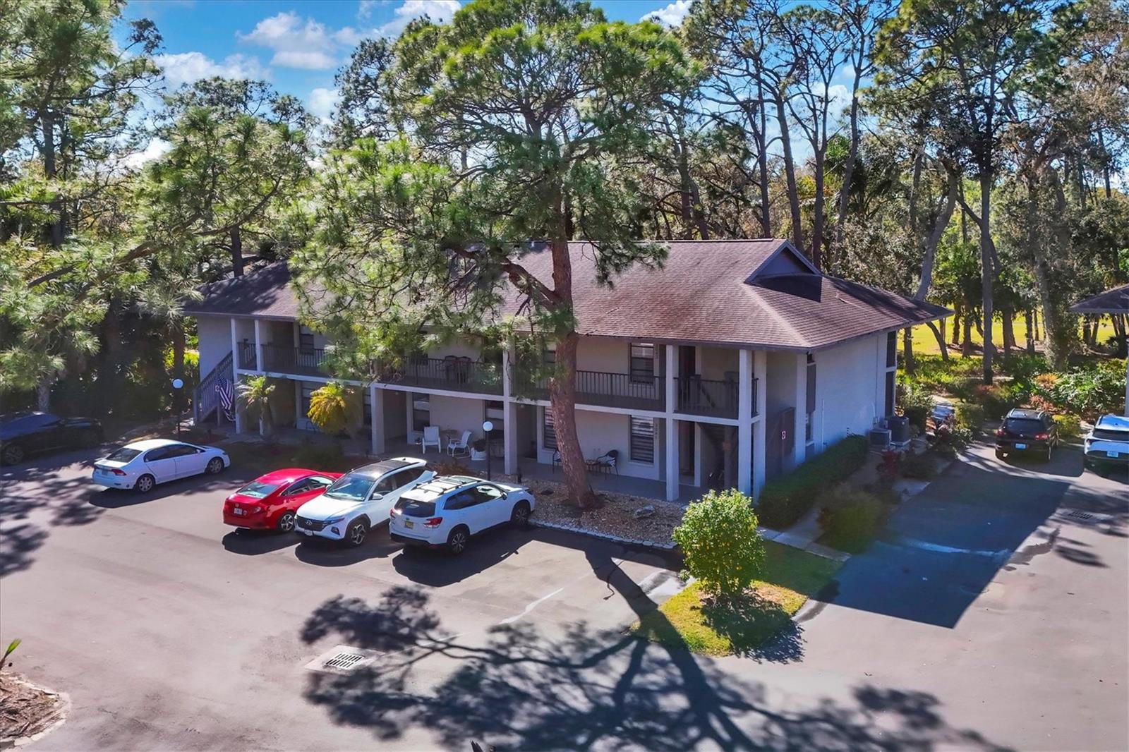 Enjoy a relaxed Florida lifestyle in this updated end unit condo in the heart of The Meadows, a calm oasis of acres of green space and nature preserves. This Quail Hollow home makes the perfect vacation getaway or a full-time residence in this maintenance-free community which enjoys some of the lowest HOA fees in the entire area! Surrounded by walking paths, mature trees, ponds, lakes and golf courses with all the exterior work taken care of for you. Entering this first-floor unit, you are greeted by the warmly updated space with wood-look flooring and gorgeous treed and green views from the living room sliding doors. The primary bedroom has a large closet and pocket door to the adjacent bathroom. The well-appointed bathroom enjoys a new quartz vanity, sink, lighting and step-in shower.  Smartly designed, the shower has the water control located so you don’t have to reach through the spray to adjust. A fully updated kitchen which has been opened up to the living space makes for easy entertaining.  The extended quartz counter creates a cozy breakfast bar including load of under counter storage, new white shaker cabinetry, white dimensional subway tile backsplash, and new appliances create a home cook’s happy place with an end unit window for extra natural light. Convenient interior laundry closet with stackable washer and dryer. HVAC with humidistat 2017, water heater 2017, roof 2014. Step into the spacious screened lanai with verdant green and towering tree vistas, with room for al fresco dining and lounging with beautiful sunsets and an added bonus of a locked storage closet. A private garden area allows for extension of the living area with lovely views. Quail Hollow has a heated neighborhood pool, for a cooling dip or a festive beverage with neighbors. Whether you are strolling across the street to pickleball, basketball, and fitness trails, or biking to the newer fitness center, additional pickle ball courts, top Har-Tru tennis facility, Jr. Olympic pool and spa or the golf courses, this condo provides the perfect Florida lifestyle, carefree and activity-filled. Private dog park and free lending library.  The convenient Village Shops less than a mile away offers a charming collection of restaurants, neighborhood pub, bank, dentist, massage, salon, market and day spa. The Meadows is just minutes by car to The Mall at University Town Center, Nathan Benderson Park for water sports and outdoor festivals, a weekly Famer’s Market, and world-class athletic competitions, Mote SEA Aquarium, Whole Foods and Trader Joe’s for fun grocery shopping, and endless dining options. A short drive to the world class beaches of Siesta Key and Lido Key and the vibrant art, culture, dining and nightlife of downtown Sarasota. Flood zone X above flood plain for peace of mind.