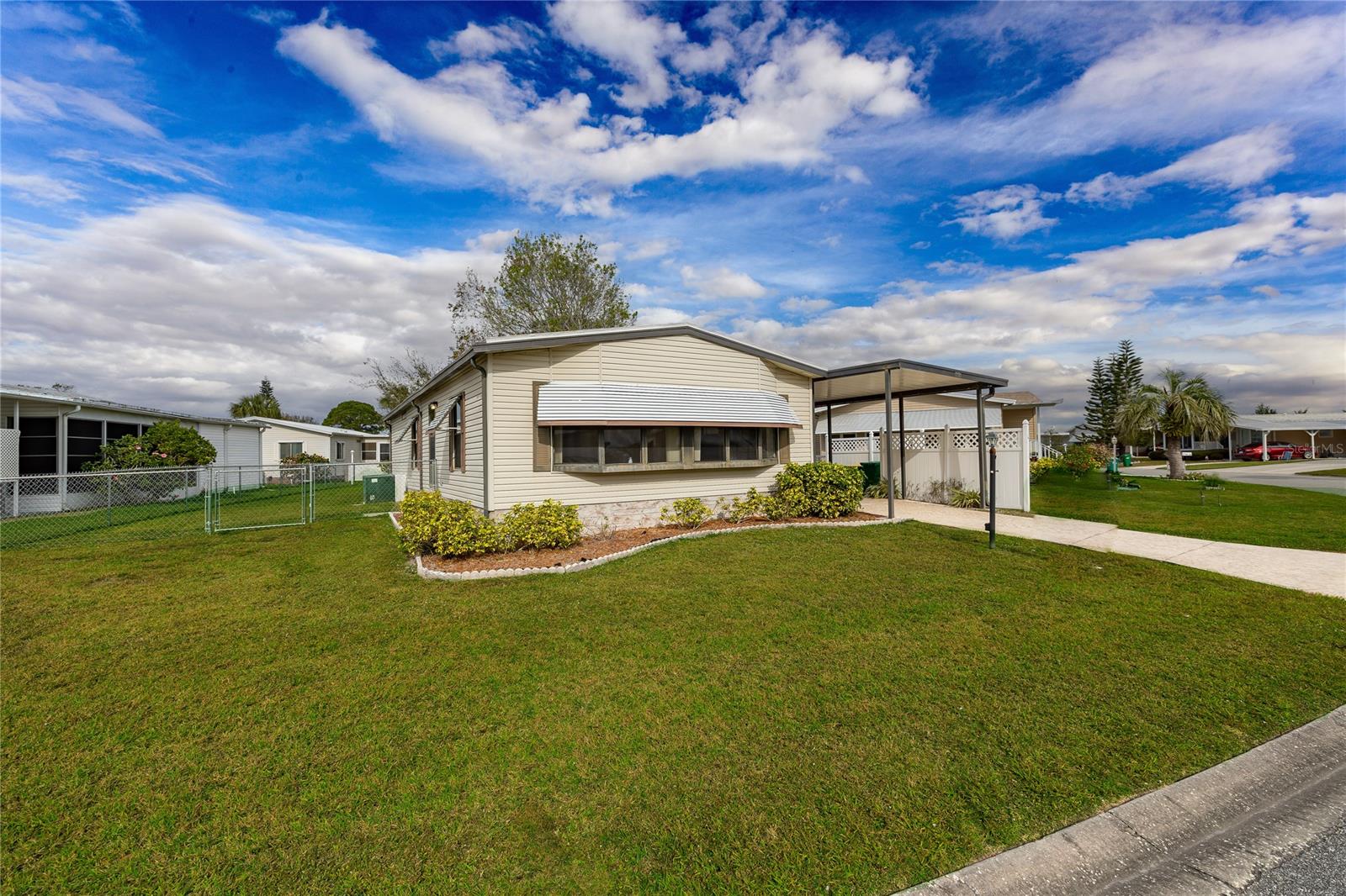 Located in Barefoot Bay, one of Florida's most prominent Mobile Communities, this home has 2 bedrooms, and 2 baths, with a screened porch, outside storage, and a utility room for a washer and dryer.  Enjoy your large master with an oversized closet.  Guestroom or office to work from home.  A fenced yard to entertain or for your furry friends.  Can you say AMENITIES!!!!  This community offers 3 pools, a clubhouse with a lounge, outside seating and a stage for live entertainment, a golf course, a shuffleboard court, a pickleball court and so much more. Don't miss out on this fun-filled lifestyle. Ask about CASH offer incentives!!!! ;Water: City