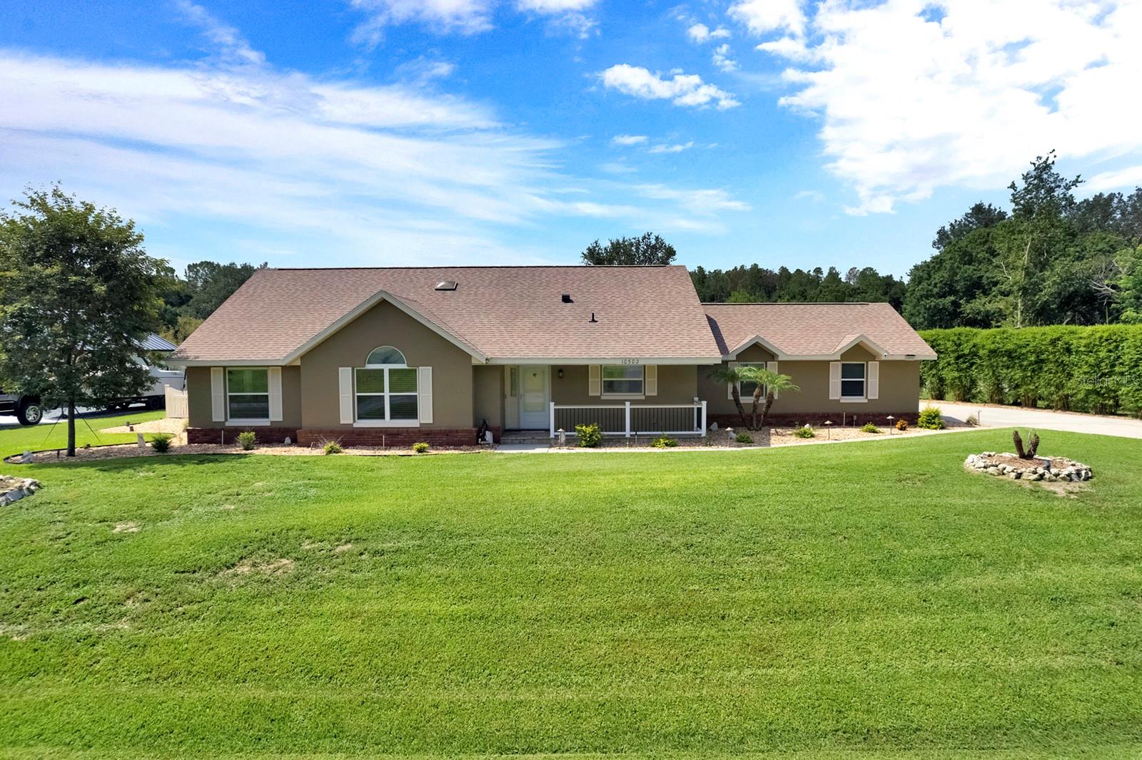Virtually Staged. One or more photo(s) was virtually staged. Welcome to this exceptional 3-bedroom, 2-bath pool home in the desirable Crescent West community of Clermont, where over $180,000 in premium upgrades create a truly one-of-a-kind property. One of the community's most desirable amenities is its private access to beautiful Lake Crescent, part of the Clermont Chain of Lakes. Main features include detached office/man cave/game room is fully climate controlled with its own A/C, insulated finished attic, dedicated security system, and built-in oversized safe, providing endless possibilities for a home business, hobby space, or private retreat and Technology and efficiency abound with a $60,000 Tesla Solar System, Tesla Dual Battery Backup System, EV charging station, water softener, Rain Bird irrigation system, smart garage door, and hurricane-rated garage door. The heart of the home showcases a beautifully updated kitchen with custom cabinetry and additional storage, while the spacious primary suite features a  custom-designed walk-in closet and a built-in safe. The third bedroom includes a convenient Murphy bed and updated closet system, making it ideal for guests or a home office. Step outside to your private backyard retreat featuring a heated, screened-in pool and spa with solar heating, LED enclosure lighting, an extended lanai with elegant tongue-and-groove ceiling, new railing, decorative pavers, and professional privacy landscaping, no rear neighbor—perfect for entertaining or relaxing year-round.  Additional highlights include custom wood trim throughout, an extended laundry room, an updated guest bath, custom garage cabinetry, premium Shark-style coated garage floor, pool deck, and office flooring, plus a comprehensive whole-house security system with cameras and monitors. This extraordinary Clermont home offers the perfect combination of luxury, energy efficiency, and an unbeatable Florida lifestyle with private lake access and exceptional upgrades throughout. Schedule your private showing today and discover everything this remarkable property has to offer.