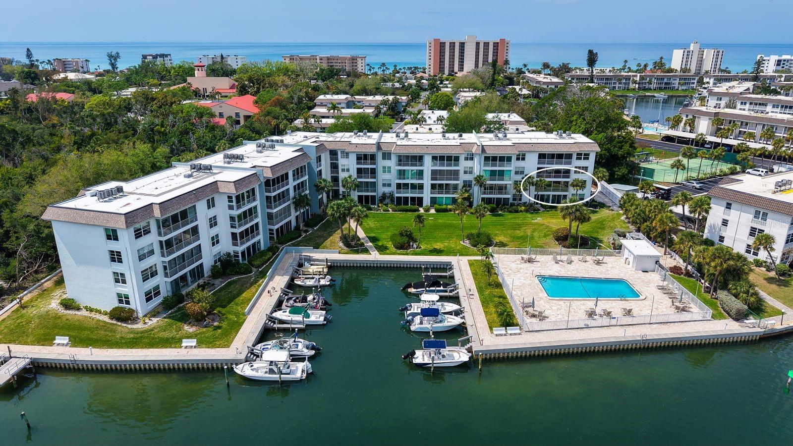 This is the one you have been waiting for!! INCREDIBLE UNOBSTRUCTED BAY VIEWS & BREATHTAKING SUNRISES from this light-filled CORNER unit in the beach-to-bay community of Sutton Place.  Enjoy stunning vistas from nearly every room through impact windows and doors! Meticulously maintained and beautifully renovated, this spacious two-bedroom, two-bath coastal retreat is truly exceptional. The thoughtfully designed open concept chef’s kitchen with premium cabinetry, plentiful storage, and Cambria quartz countertops seamlessly connects to the expansive living area through a custom dining island with wraparound seating. Plantation shutters throughout the kitchen and living area add to the coastal island feel. The enclosed lanai, featuring walls of glass that span along the rear of the unit, provides an ideal setting for morning coffee, evening relaxation, remote work, or accommodating additional guests. The spacious primary and secondary bedrooms provide exceptional views, each with direct access to the lanai through impact-rated sliding doors. The serene primary bedroom boasts a generous walk-in closet fitted with a custom organizer and an elegantly renovated bathroom with a walk-in shower, complete with a linen closet. The secondary bedroom offers ample storage with a double closet, also fitted with custom organizers. The adjacent guest bath has been tastefully renovated. Parking is easy with a covered, assigned space in a convenient location, plus plenty of overflow and guest parking. While the stairs are easily accessible; there is also an elevator for added convenience. The in-building storage unit provides extra space for any additional storage needs. Sutton Place offers a wide range of amenities, including two heated swimming pools, a community clubhouse, marina facilities with boat slips (current wait list but only $300 annually!!), kayak storage equipped with electric launch, a fish cleaning station, designated grilling areas, car wash stations, and deeded beach access with private beach pavilion featuring storage lockers, showers, and restrooms. The community successfully endured the recent storms, experiencing minimal overall damage and no impact to any individual units. With its exceptional location, unmatched views, and wonderful amenities, this property is an opportunity not to be missed!  Schedule your private showing today!