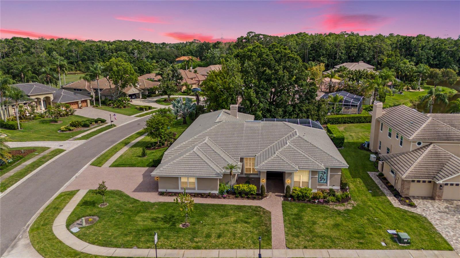 Welcome to this beautifully updated Arthur Rutenberg estate, perfectly positioned on a premium corner homesite with partial pond views and exceptional privacy in the sought-after Aberdeen enclave of East Lake Woodlands. This move-in-ready residence offers 5 bedrooms, a versatile bonus room with a wet bar, and 3.5 bathrooms, providing the ideal blend of luxury, comfort, and functionality. Extensively remodeled in 2021, the home showcases timeless design, quality craftsmanship, and modern finishes throughout.

Upon entering, you are greeted by an abundance of natural light, soaring ceilings, and gorgeous Mohawk engineered wood flooring that flows throughout the main living areas. The heart of the home is the fully renovated kitchen, featuring a massive waterfall-edge island, crisp white shaker cabinetry, quartz countertops, high-end stainless steel appliances, and stylish Pottery Barn pendant lighting. The kitchen opens seamlessly to the breakfast nook and inviting family room, where a redesigned brick fireplace and custom mantle create a warm and elegant focal point.

Designed for the Florida lifestyle, the living spaces transition effortlessly to the spectacular outdoor oasis. The expansive, recently rescreened pool enclosure showcases a sparkling PebbleTec pool with a tranquil rock waterfall, all surrounded by upgraded pavers. Whether hosting family and friends or enjoying a peaceful evening at home, this outdoor retreat is perfectly suited for both entertaining and relaxation.

The primary suite serves as a private sanctuary, offering direct lanai access, custom-built closet organizers, and a spa-inspired en-suite bathroom complete with a soaking tub, dual vanities, and elegant finishes. The highly adaptable bonus room provides the perfect space for a game room, media center, home office, or multi-generational living area, complete with its own wet bar.

Practical upgrades and peace of mind abound throughout the home. A brand-new HVAC system was installed in March of this year, and the property also features a 5-year-old water heater, a newer water softener, and fresh interior paint completed during the 2021 renovation. The oversized 3-car garage provides ample storage and showcases a sleek, durable epoxy floor.

Aberdeen is a tranquil oasis featuring quiet streets, mature tropical landscaping, and abundant wildlife within the gated East Lake Woodlands community. Residents enjoy convenient access to top-rated schools, world-class beaches including Clearwater Beach and Honeymoon Island, major medical facilities, shopping, dining, and both Tampa International Airport and St. Pete-Clearwater International Airport. Optional Ardea Country Club memberships provide access to two championship 18-hole golf courses, premier tennis facilities, resort-style swimming, fitness amenities, dining venues, and a vibrant social calendar.

Combining timeless Arthur Rutenberg craftsmanship, extensive modern updates, resort-style outdoor living, and an exceptional East Lake Woodlands location, this remarkable residence offers a rare opportunity to enjoy the very best of Florida living. Schedule your private showing today.