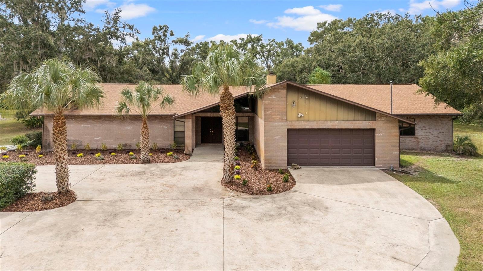 Price adjustment below appraised value. Muat see this tucked away property which features both privacy and seclusion right in the heart of Brandon. Non subdivision no HOA fees. 3.3-acre parcel that offers a playground for owners of RV's, boats, and other hobbies and toys. A gated entrance off the public road leads you along a walled, driveway to the home. There are 3 different garage/workshops to choose from. Custom built home features a unique, huge, in-ground pool that is located on the covered lanai with a 1/2-bathroom, wet bar and a wood- burning fireplace. Surrounding deck is non-slip, river-rock. Glass doors along exterior of the lanai give an uninterrupted view of the private, rear yard. The main home features 5 bedrooms and 2.5 bathrooms. Prepare to be impressed when you enter the front door with a formal living room and dining room, dramatic, soaring, wood ceiling, plus a sunken conversation area that has a cozy seating area and a fireplace. The kitchen has been upgraded and is adjacent to a breakfast nook. The family/recreation room has high ceilings and plenty of room for ping-pong, pool tables and other entertainment. On that side of the home are 2 more bedrooms with closets that are being used as an office and exercise room. Windows on the West side of home have 3M- energy efficient film to save on electricity. Honeycomb shades in most of the home windows will stay. There is a 2-car garage off the family room. Long time owners have updated the spacious, primary suite and bathroom. You will enjoy the private access to the pool. 2 guest bedrooms with an upgraded bathroom are on that side of the home. Plus, a laundry room, that has spacious cabinets and extra space for crafting/sewing etc. Washer and dryer will stay. There are two large separate garages off the circular driveway. 1st building is 39x21 and features a 2-car garage, plus a workshop with a 15ft. roll-up door. It also has a bathroom and a finished room that can be used for storage or converted into an in-law, small apartment. There is an adjacent RV carport beside this building. A newer, separate 4 car-garage adds more space for owners with multiple cars. Perfect for owners with up to 8 cars or other vehicles. The owners had poultry and there is a small enclosure that can easily be made ready for chickens or other pets. Property is zoned RSC-2.  House has 4,224 sq. ft. of living area. There is room to roam here and add on to as needed. Bring your horse if you have one. Owner giving a buyer concession of $8K at closing plus a 1 year AHS warranty for buyer peace of mind. Nearby shopping, good schools and quick access to I75, Selmon Expressway, Gulf beaches and downtown Tampa make living here very special. Priced below recent appraisal. Hurry today and see for yourself how you can enjoy the best of Florida in your own private oasis.