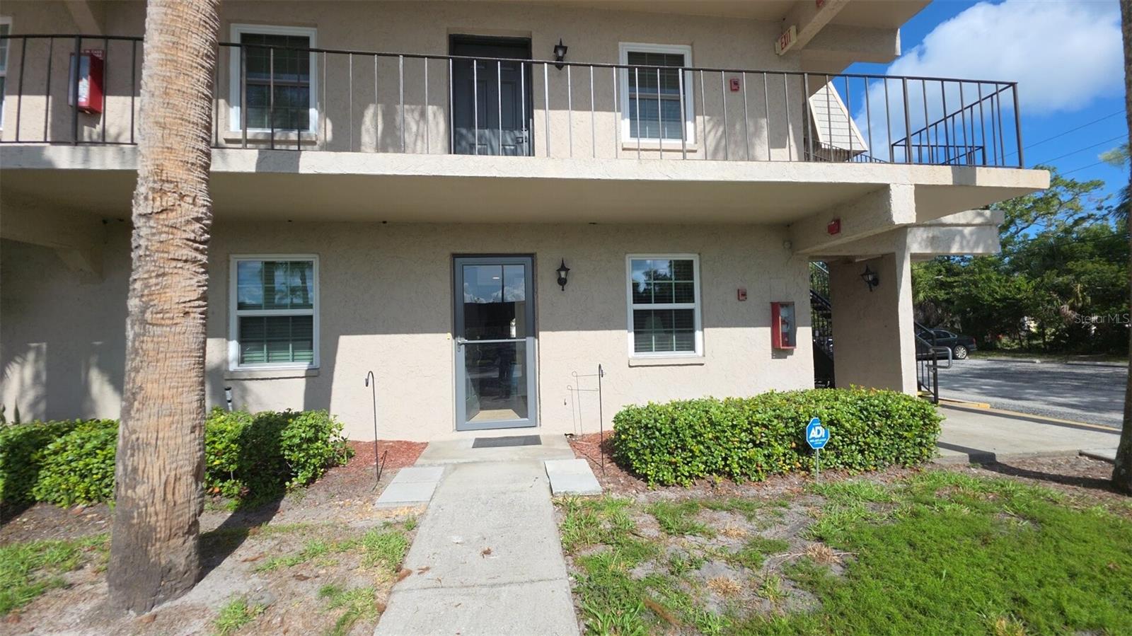 COMPETITIVELY PRICED and fully renovated, this RARE GROUND FLOOR CORNER UNIT delivers ultimate peace of mind with a 2024 ROOF, 2024 A/C, and NEW IMPACT WINDOWS AND DOORS. Skip the elevators and step directly into a modernized space featuring a highly sought-after DUAL MASTER SUITE layout. The redesigned kitchen operates efficiently with soft-close white cabinetry, GRANITE COUNTERTOPS, and a complete suite of NEW GE STAINLESS STEEL APPLIANCES. Woodgrain laminate plank flooring runs seamlessly through the main living areas. Enjoy effortless indoor-outdoor living with DOUBLE SLIDING GLASS DOORS accessing the patio from both the main living room and the secondary bedroom. These lead to the distinct competitive advantage of this specific unit: TWO PRIVATE OUTDOOR SPACES. The covered patio houses your private storage closet complete with an INCLUDED STACKED WASHER AND DRYER, flowing directly into a massive 13x10 OPEN AND GATED PRIVATE PATIO that doubles your outdoor entertainment footprint. Both bedrooms operate as true primary suites with overhauled en-suite bathrooms featuring frameless glass enclosures, custom tiled showers, rain shower heads, and bright new vanities. Positioned in the desirable Cordova Greens community, the location offers quiet luxury and daily convenience. You are one mile from the Bardmoor Golf and Tennis Club, five minutes from the shopping and dining, and under fifteen minutes to the Gulf beaches. Maintenance-free living is secured with a comprehensive HOA covering water, sewer, cable, high-speed internet, and exterior upkeep.