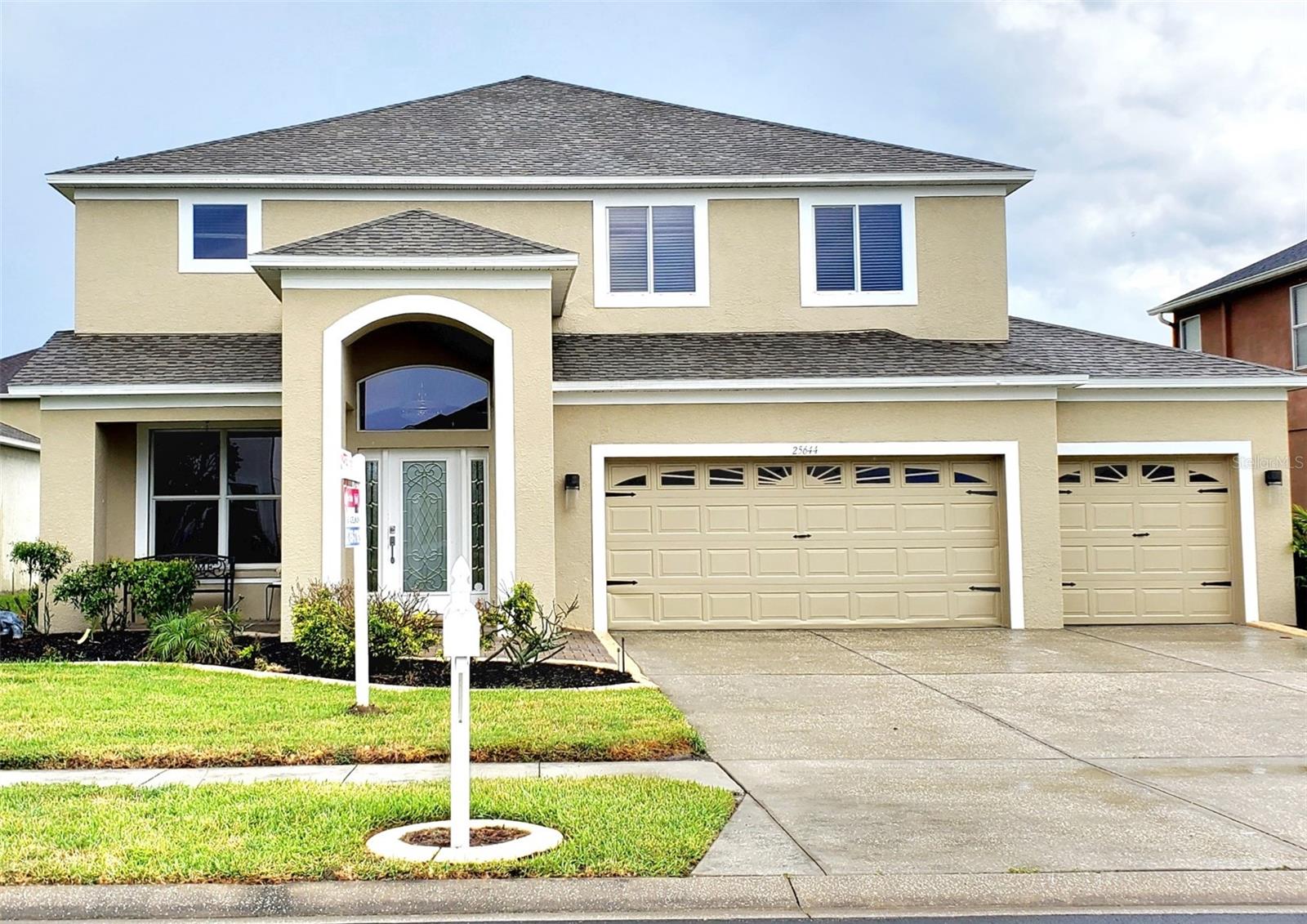 **MANSION FOR THE MONEY!** Where else can you find nearly 3,000 square feet with a new roof overlooking a scenic lake in a neighborhood with luxury amenities for around $500K?! That’s not all—you’ll also enjoy a newly renovated kitchen with brand-new cabinets, stainless steel appliances, and quartz countertops! Not to mention a luxury master suite you’ll never want to leave—an enormous space with tray ceiling and an adjoining bonus room or office! Double doors open to an elegant, updated master bathroom featuring a garden tub, glass shower, and double vanity, with his-and-her walk-in closets as the perfect finishing touch. Down the hall are three spacious bedrooms and two full bathrooms. Downstairs offers both a living room and a family room with a fireplace. Step through the sliding glass doors to a large screened lanai with brick pavers—an incredible spot for entertaining with stunning lake views! You’ll also find a fourth bathroom and laundry room just off the 3-car garage. The Grand Oaks clubhouse, pool, park, and playground are just a short walk away. This home truly has it all at an amazing price!