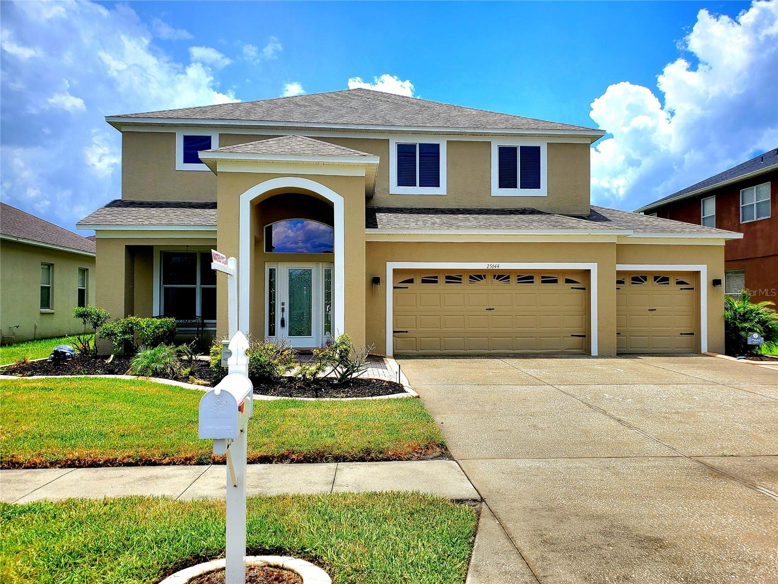 **MANSION FOR THE MONEY!** Where else can you find nearly 3,000 square feet with overlooking a scenic lake in a neighborhood with luxury amenities for around $500K?! This home boasts incredible curb appeal with a brand-new roof (2024), a freshly painted exterior, and a charming paver porch and walkway! That’s not all—you’ll also enjoy a newly renovated kitchen with brand-new cabinets, stainless steel appliances, and quartz countertops! Not to mention a luxury master suite you’ll never want to leave—an enormous space with tray ceiling and an adjoining bonus room or office! Double doors open to an elegant, updated master bathroom featuring a garden tub, glass shower, and double vanity, with his-and-her walk-in closets as the perfect finishing touch. Down the hall are three spacious bedrooms and two full bathrooms. Downstairs offers both a living room and a family room with a fireplace. Step through the sliding glass doors to a large screened lanai with brick pavers—an incredible spot for entertaining with stunning lake views! You’ll also find a fourth bathroom and laundry room just off the 3-car garage. The Grand Oaks clubhouse, pool, park, and playground are just a short walk away. This home truly has it all at an amazing price!
