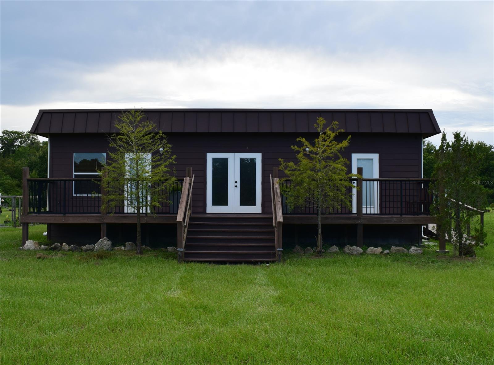 Looking for space in the country yet minutes to the city? This is it!! Located a mile and a half down the private dirt road off of State Road 44 and sitting on 32.6 acres is this 3 BR/1.5 BA modular home with unlimited possibilities. Enjoy morning coffee in your large kitchen overlooking the back yard. Sit on the front porch or take the 4 wheeler for an evening adventure. Relax in your large soaking tub with a glass of wine while watching your favorite show. Bring your horses, cows, ATV’s, RV. 17.6 acres are cleared and high and dry. Currently zoned A-1 with potential to be re-zoned. All within minutes to shopping and restaurants and only 15 minutes to the beach.