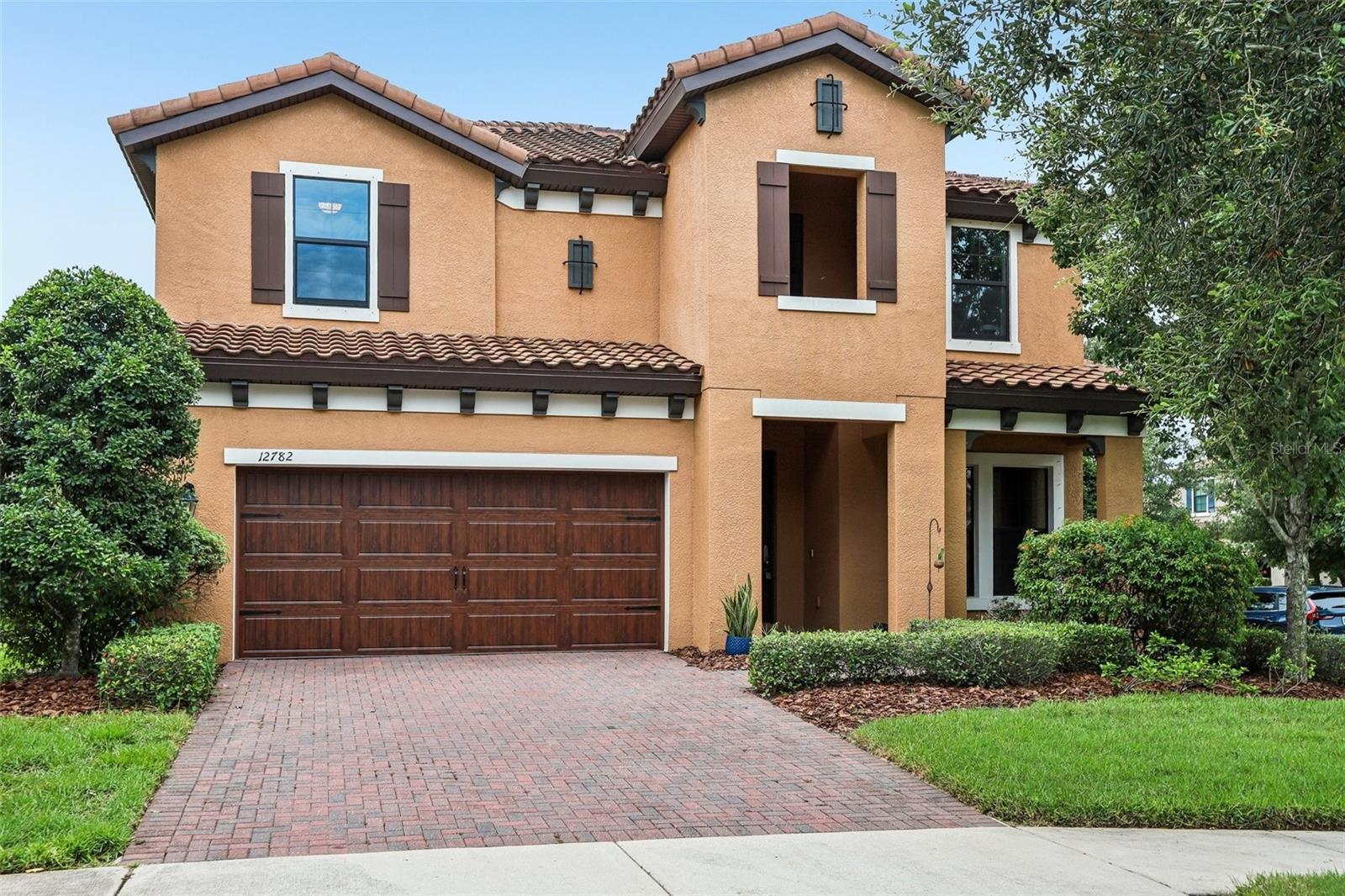 Experience the perfect blend of luxury, space, and functionality in this impressive **6-bedroom, 4-bathroom** Mediterranean-style home situated on an oversized corner homesite. From the moment you arrive, the paver driveway, inviting front porch, and elegant curb appeal set the tone for what awaits inside. Step through the glass entry door into a bright and welcoming foyer. Just off the entrance, a spacious flex room behind French doors offers endless possibilities as a home office, formal sitting room, playroom, or study. Designed with entertaining in mind, the heart of the home is the stunning chef's kitchen featuring a massive center island, built-in oven and microwave, 5-burner gas cooktop, abundant cabinetry, and generous prep space. The kitchen flows seamlessly into the dining area and expansive family room, creating an open-concept layout ideal for both everyday living and hosting guests. Sliding glass doors lead to your private backyard retreat. Enjoy Florida living year-round from the screened lanai overlooking the sparkling pool and relaxing spa. The **fully fenced backyard** provides added privacy and plenty of space for pets, play, and outdoor entertaining. A first-floor guest bedroom and full bathroom offer privacy and convenience for visitors or multigenerational living. Upstairs, you'll find **five additional bedrooms**, including a spacious primary suite with room for a sitting area, dual vanities, a large walk-in shower, private water closet, and oversized walk-in closet. The second floor showcases **new flooring throughout**, adding a fresh, modern touch to the home's already impressive living spaces. A generous bonus room provides the perfect setting for a media room, game room, or secondary living area. An additional bedroom with adjacent bath offers flexibility for guests, while the remaining bedrooms are generously sized and served by another full bathroom. The upstairs laundry room is conveniently located near the bedrooms. Additional features include a water softener, washer, dryer, refrigerator, security system, hurricane shutters, ceiling fans, window blinds, reclaimed water irrigation, and no flood insurance requirement. The home also includes a transferable structural warranty and a one-year home warranty with an accepted contract. Located in one of Tampa Bay's premier master-planned communities, residents enjoy resort-style pools, playgrounds, dog parks, miles of walking and biking trails, kayak and canoe launches, community events, and over 800 acres of preserved natural beauty bordering the Starkey Wilderness Preserve. Conveniently located near shopping, dining, top-rated schools, a public library, and everyday conveniences, this move-in ready home offers an exceptional lifestyle in a thriving community.