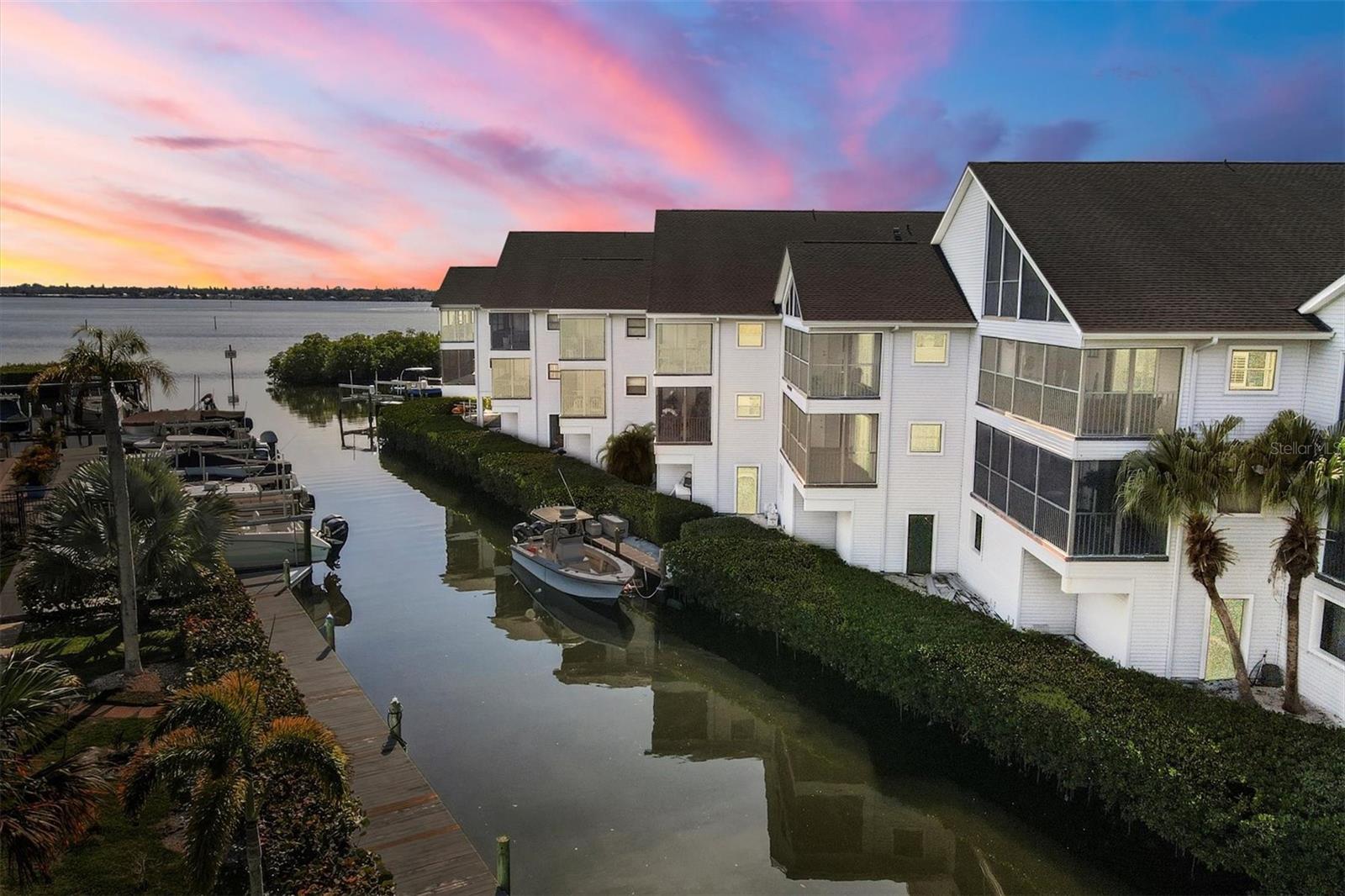 Welcome to one of the best kept secrets on the Manatee River! Waterfront condo with boat slip for under $500k! Lovely, recently renovated condo with 2 bedrooms, 2 baths, 2 walk-in closets & a huge screened in patio overlooking the community & the water. Open floorplan, single level condo with elevator for ease and convenience (no steps!). The large kitchen features new cabinets, granite countertops, Frigidaire appliances, lots of storage, a breakfast bar & breakfast nook that could easily double as an office. Neutral toned luxury plank vinyl flooring throughout, soft tropical paint tones & plantation shutters in both bedrooms will serve as the perfect backdrop for a light & bright coastal luxury furnishings & decor. The guest bath has the most amazing custom walk-in Hydro tub which will quickly become the indulgence you didn’t know you had always needed. Outside, the protected alcove marina with deep water and convenient, extra spacious corner dock. Lift supports at least up to 15,000 lbs or possibly more with recent upgrades including new cables, pulleys, aluminum step up and new wood dock and supports. There’s even a community fish cleaning station big enough for your largest catch. Cost savings peace of mind afforded with the many recent renovations both inside and outside, including newer roof, siding, walkways (project almost complete), elevator and more. Annual rentals allowed. River Place, an intimate 24 unit condo enclave, offers an excellent assortment of amenities ideal for both outdoor enthusiasts and those still hoping for the conveniences of owning a home, including a community pool, tennis courts, kayak/paddleboard storage, grill storage as well as a community grill, community garden, a car washing station, & ample extra storage on the patio & also a large 10x6’ storage room behind one of two designated parking spots. Large dogs welcome too! Very close to both 41 & I-75 for quick access in every direction. For a special date night or simply because you don’t want to cook, motor over to Whiskey Joe’s, Woody’s River Roo or Pier 22 on the water. Shake Station, Detwiler’s Farm Market, Ellenton Premium Outlets & the Ellenton Sports & Ice Complex only a few minutes away by car too. For nature enthusiasts, enjoy the quietude onland at Felts Audubon Preserve, a nature sanctuary less than 4 miles north. Let the soft sunrise sunshine vibes set the tone for lovely days ahead…. The manatees, dolphins, herons & resident Kingfisher are waiting for you to come enjoy the tranquility too!