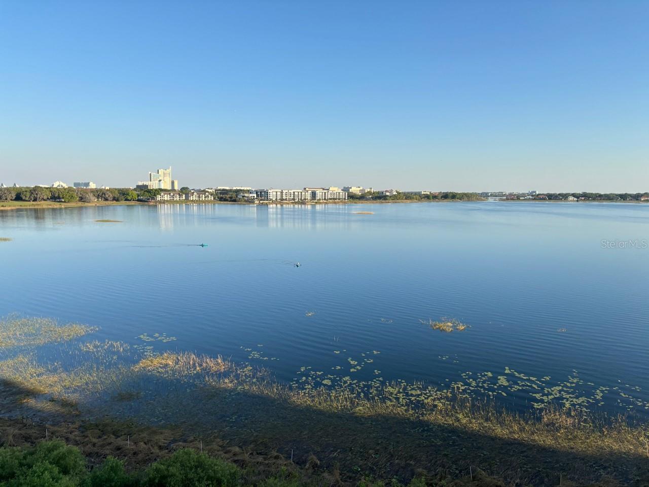 Experience breathtaking waterfront living in the heart of Dr. Phillips at 8749 The Esplanade #22 in the highly sought-after Vizcaya community. This beautifully updated 2-bedroom, 2-bath condominium is located on the 4th floor and offers stunning panoramic views of Big Sand Lake and Little Sand Lake, creating a picturesque backdrop from sunrise to sunset along with nightly fireworks from Universal Epic and Disney. The spacious interior features tile flooring throughout, a well-appointed kitchen with granite countertops and stainless-steel appliances, and an open living and dining area designed to showcase the incredible lake views. Both bedrooms enjoy tranquil water vistas, providing a peaceful retreat at the end of the day. Step onto the private balcony and take in sweeping waterfront views stretching across the lakes and surrounding skyline. On clear evenings, enjoy views toward Universal Orlando, Pointe Orlando, and the Disney area, creating a truly unique Central Florida living experience. This residence includes a designated parking space and a private storage room in the building’s basement for added convenience. Vizcaya is one of Orlando’s premier gated waterfront communities, offering residents access to a clubhouse, resort-style swimming pool, tennis courts, fitness facilities, and beautifully maintained grounds. Ideally located just a short walk from the renowned Restaurant Row on Sand Lake Road, you’ll enjoy immediate access to award-winning restaurants, upscale shopping, entertainment, and everyday conveniences. The home is also just minutes from Bay Hill Club & Lodge, Universal Orlando Resort, Walt Disney World, International Drive, and major transportation routes. This is a rare opportunity to own a move-in-ready waterfront condominium with spectacular views in one of Orlando’s most desirable locations. A/C 2019; Water heater 2014; Subzero refrigerator 2014; Bosch DW 2018; Monogram Advantium microwave and GE Monogram Convection Wall Oven 2014; crown molding in dining and family room; California closet system in primary closet; Updated primary bathroom; Plantation shutters on all windows with 6'8" roller shades on master picture window; Windows and sliding glass door are double pane, low-e, argon gas.