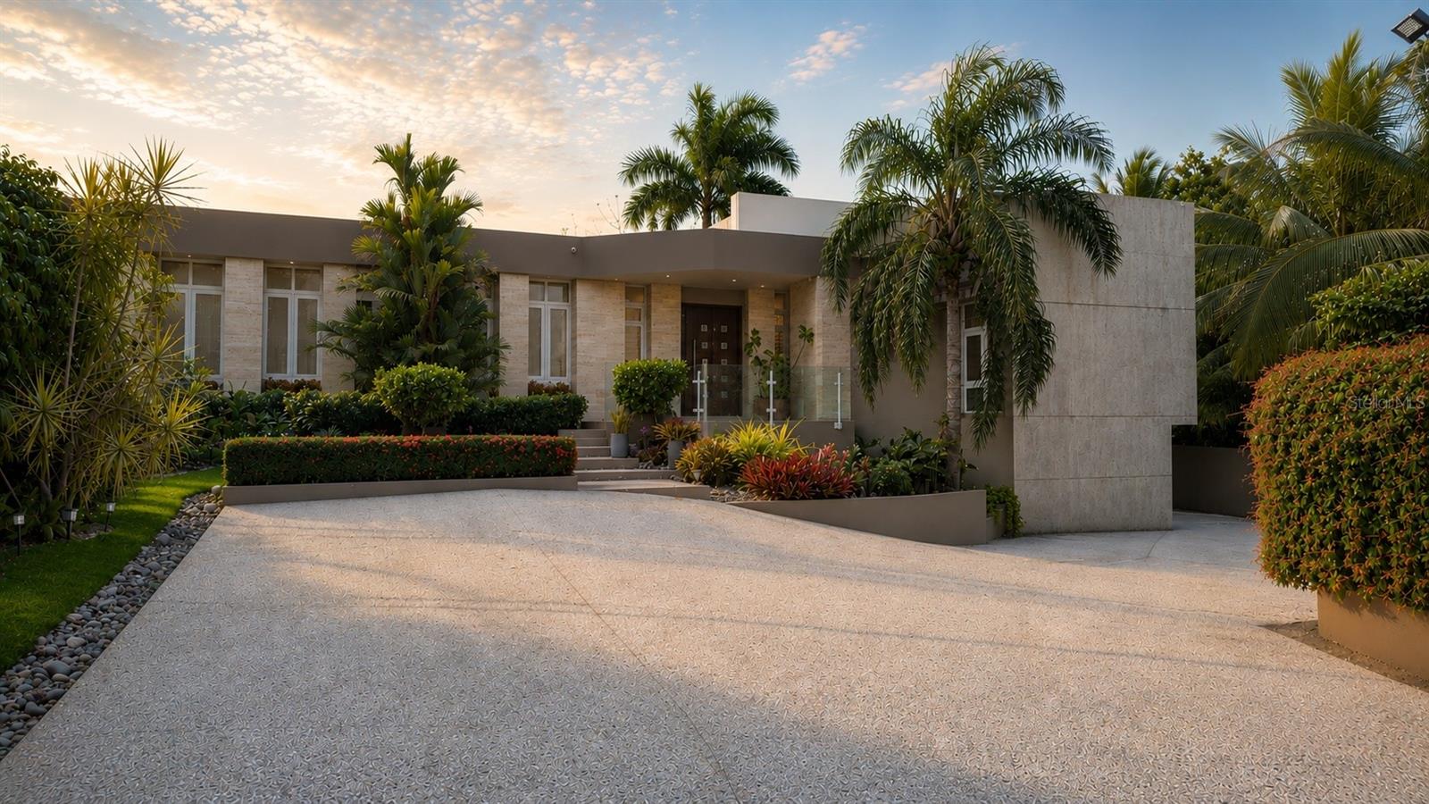 A Contemporary Tropical Retreat Without HOA Restrictions

A contemporary tropical retreat designed for the way modern families truly live: balancing elegance, comfort, flexibility, and effortless entertaining in one of Guaynabo’s most connected residential locations.

Set on an expansive 1,689 m² lot positioned just outside the gated entrance of Colinas de Parkville, this residence offers approximately 4,774 living sq. ft. and 5,592 total sq. ft., delivering the rare combination of residential independence, flexibility, and tropical living.

From the moment you enter, the home unfolds through a series of warm, interconnected living spaces, where expansive windows and mature tropical landscaping create an atmosphere that feels both elevated and inviting. Designed for both everyday living and entertaining, the property blends modern design with a welcoming residential feel rarely found in contemporary homes.

At the center of the home, the family room, game room, and pool area create a true indoor-outdoor lifestyle experience ideal for entertaining in Puerto Rico’s year-round tropical climate. The game room features a skylight, built-in bar area, and billiard table, while oversized openings connect directly to the private pool with decorative waterfall feature, creating an ambiance reminiscent of a modern tropical resort.

The main level features four bedrooms, including two spacious primary-style suites with ensuite bathrooms and walk-in closets. 

The lower level features an additional guest suite seamlessly integrated into the home’s interior layout, complete with ensuite bathroom and the added convenience of private exterior access. A separate bonus room adds even more versatility as a media lounge, podcast studio, wellness space, creative room, or additional storage area.

Designed for both lifestyle and peace of mind, the property includes a HIPOWER 40 kVA industrial diesel generator with transfer switch and 200-gallon tank, impact-resistant windows and terrace doors, electric storm shutters, solar water heater, water purification system, wireless Honeywell alarm system, 16-camera CCTV system, and Danosa roof treatment with 10-year warranty completed in 2022.

Unlike many luxury properties in Guaynabo, the residence is not subject to HOA regulations, offering a more flexible and independent lifestyle while still benefiting from the comfort of an established and highly convenient residential setting.

Mature tropical landscaping, generous parking, and private gated access further enhance the residential experience, all while remaining minutes from top private schools, hospitals, restaurants, shopping centers, sports facilities, pickleball and tennis courts, and major highways.

A modern tropical home in Puerto Rico designed not simply to impress — but to truly live in.