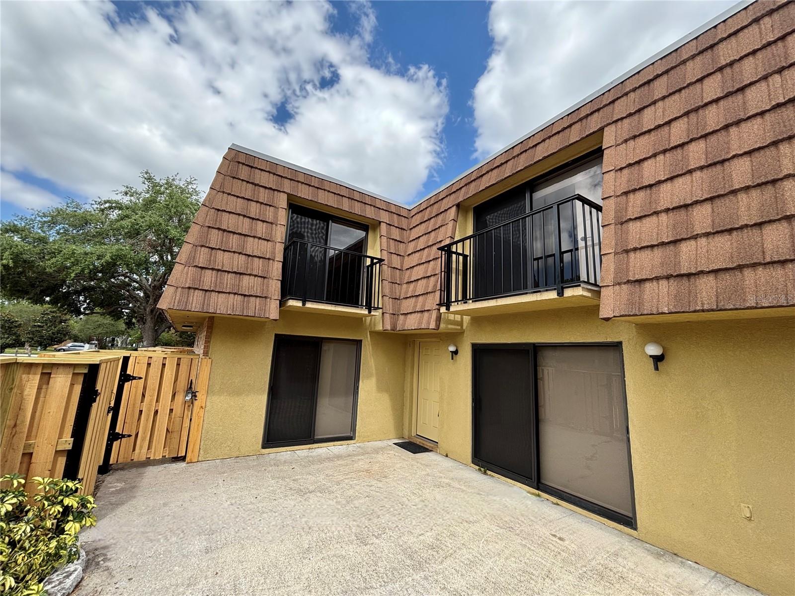 **Some photos are virtually staged** Beautifully updated two-story townhome in the heart of the Conroy area. Close to shopping, restaurants, attractions, and Valencia College. This 2 bedroom/2.5 bath light-filled home has new cabinets in kitchen and baths, new luxury vinyl wood-look planking throughout, new hardware, fresh paint and light/fan fixtures, newer stainless appliances. Downstairs, the roomy living room looks out on a large private fenced patio with new fencing. The kitchen which also looks out on the patio features new cabinetry, Corian counters, stylish tile backsplash, stainless appliances, and all new hardware. Master bath has new double vanity as well as new shower/glass door/tile. Master closet features a built-in organizer. Second bedroom also with ensuite bath has complete upgrades including a built-in storage system wall. Large slider windows in both upstairs bedrooms look out on balconies. Powder room downstairs also functions as a convenient laundry room - washer and dryer included! And plenty of storage in the under-stairs closet. Middlebrook Pines community fees include access to a pool, tennis courts, clubhouse, racquetball court, car wash area. Exterior maintenance, including roof and landscaping is handled by the HOA. Home has two designated parking spots just steps from the front door. There's nothing you need to do but move in!