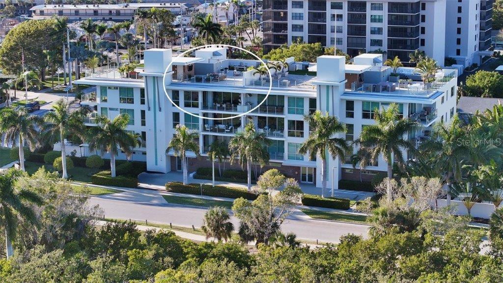 Enjoy the coveted seaside lifestyle in this exquisite Park Residences penthouse with 2,458 sq. ft. of living space and an additional 2,250 sq. ft. on your private rooftop terrace boasting breathtaking Gulf and Bay views. Moments away from the aqua-green waters of the Gulf of Mexico and South Lido Park, this residence immerses you in an unparalleled beach-town lifestyle, where gentle rolling waves, serene park vistas, and luxurious living converge seamlessly. Crafted with precision in a coastal-modern contemporary style, this condominium features eco-friendly materials, impact glass storm protection, and sophisticated details including 8’ solid core doors with Schlage Latitude hardware. Elegant double front entry doors lead to a world of refinement, complemented by energy-saving tinted, low E-coated glass, upgraded modern trim, and recessed lighting throughout. The dining room boasts a dry bar with cabinets and a U-line beverage refrigerator. The kitchen is a culinary haven with European-style Cuccine Ricci cabinets, two-tone custom Caesarstone quartz countertops, subway tile backsplash, and luxurious Viking stainless steel appliances. The primary bedroom exudes comfort with two spacious walk-in closets and spa-like bath with floating double vanity, custom Caesarstone quartz countertops, Kohler fixtures, an oversized shower, and a MAAX soaking tub. The living room showcases large sliding glass doors with motorized shades that open onto a deep, covered terrace. Alfresco living is at its best with Artisan barbecue grill, cypress wood ceiling, glass railing, and unobstructed views of Ted Sperling Park. The private rooftop terrace adds 2,250 sq. ft. of living space with panoramic Gulf and Bay views. This outdoor Living Room features another Artisan barbecue grill, 2-burner range, beverage refrigerator, and granite countertops – it is ideally suited for entertaining large groups or intimate gatherings under the stars. The residents of Park Residences have exclusive access to luxe amenities including a large private courtyard, resort-style pool and spa, custom fire pit, poolside cabanas, bicycle and kayak storage, and keyless building entry. Two secure, under building parking spaces are side by side with an additional storage area. It’s time to elevate your coastal living experience in this meticulously designed residence just moments away from the best of everything on Lido Key and Sarasota.