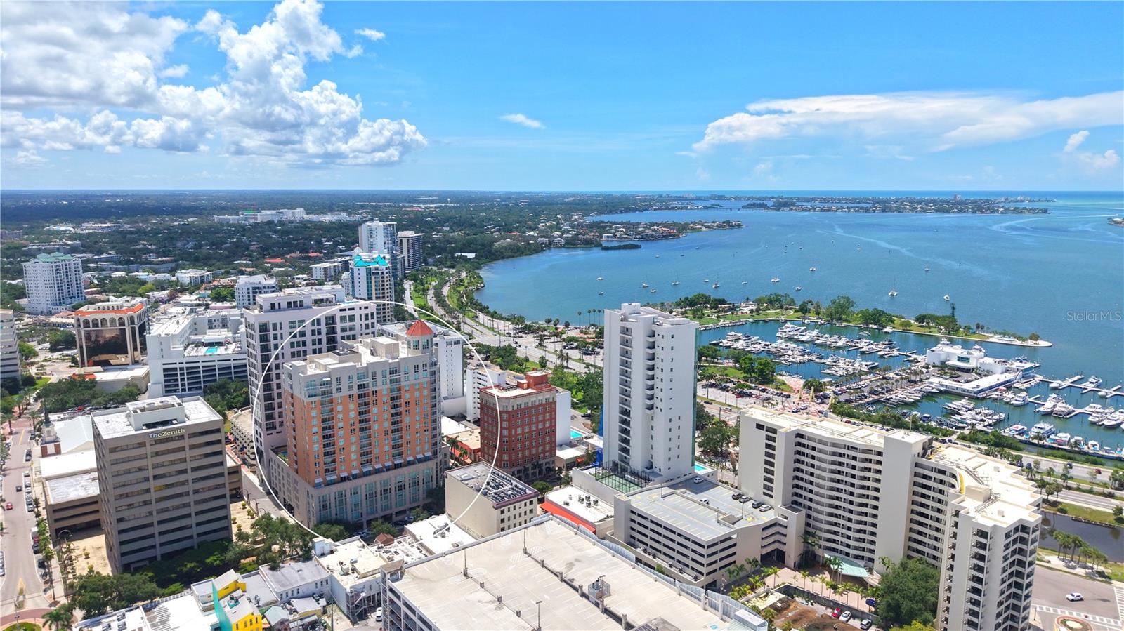 Experience the best of downtown Sarasota living in this light-filled residence, ideally positioned in the heart of the city with an exceptional walkable lifestyle. Restaurants, coffee shops, galleries, the marina, and Sarasota Bay are just steps from your door, placing you at the center of Sarasota’s vibrant cultural and culinary scene. Located on the desirable bayfront-facing side of the building, the residence enjoys open views along Palm Avenue and abundant natural light through expansive windows and sliding glass doors.
The private balcony offers the perfect vantage point for morning coffee or evening relaxation while overlooking the energy of downtown. Inside, high ceilings and an open-concept layout create an inviting sense of space. Tile flooring flows throughout the main living areas, connecting seamlessly to the European-style kitchen. Designed for both everyday living and entertaining, the kitchen features streamlined cabinetry, generous counter space, stainless steel appliances, and a serving bar that opens to the living area.
The oversized bedroom serves as a peaceful retreat, complete with a spacious walk-in closet and a well-appointed en-suite bath featuring dual vanities, a soaking tub, and a frameless glass shower. A separate powder room, ample storage, and a building-wide water softener and filtration system add everyday comfort and convenience.
This pet-friendly residence includes one assigned parking space and a climate-controlled storage unit. Residents enjoy access to a full suite of amenities, including 24-hour concierge service, a state-of-the-art fitness center with steam rooms, a 72-foot heated lap pool and spa, media and social rooms, a library, and a guest suite for visiting friends and family (available on a first-come basis).
Step outside and enjoy Sarasota’s renowned lifestyle offerings—walk to the farmers market, dine along Palm Avenue, attend performances at the Sarasota Opera House or Van Wezel Performing Arts Hall, or head over the bridge to Lido Key Beach and St. Armands Circle. Whether as a full-time residence or seasonal retreat, this downtown Sarasota property delivers modern comfort, resort-style amenities, and unmatched proximity to everything that defines city living on Florida’s Cultural Coast.