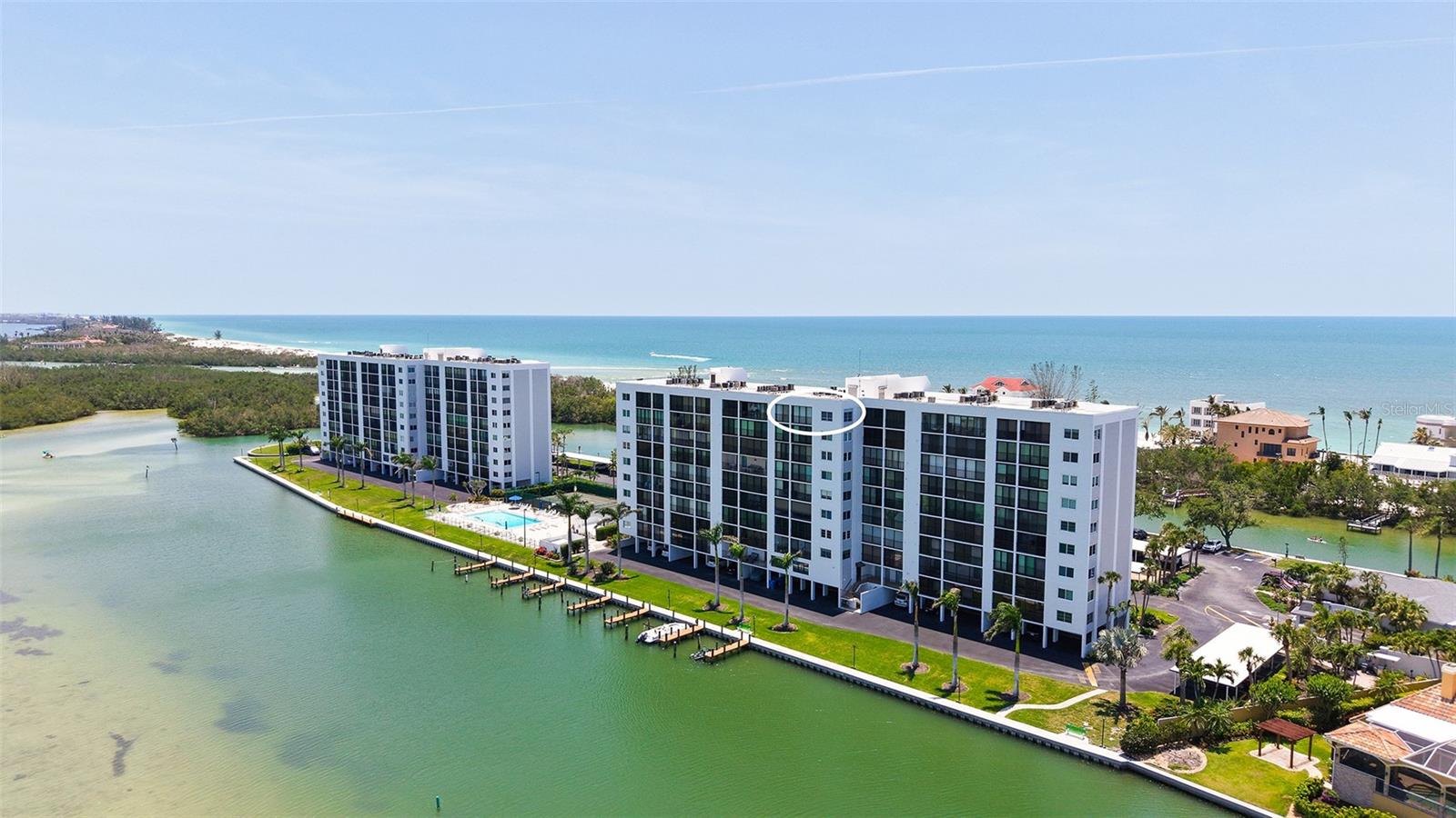 Price Reduction!! ENJOY AWE-INSPIRING SUNRISES AND SUNSETS from this stunning two bedroom, two bath PENTHOUSE condo at the southernmost end of Siesta Key. A corner unit with extra windows, enjoy water views from every room!  Wake to breath-taking sunrises over Neville Preserve on Little Sarasota Bay and marvel at spectacular sunsets over the Gulf of Mexico.  The largest of units offered at The Pointe, this 10th floor residence is filled with natural light through abundant windows and sliding glass doors.  The large kitchen opens to the living room which features beautiful engineered hardwood flooring, crown and base molding, and ceiling beams to separate the dining and living areas.  A generous screened and glassed lanai - accessible from both the living room and the primary suite - provides your front-row seat to sunrises, downtown Sarasota, and spectacular wildlife.  The private primary retreat offers a large bedroom, a walk-in closet, a built-in vanity with sink, and an ensuite bath with walk-in shower, second sink and toilet.  A comfortable guest bedroom and full hall bath complete the main living space.  A large laundry room with ample cabinetry, a walk-in utility room off the lanai and a large ground floor assigned lock-off bin provide coveted storage space.  An oversized under-building parking space convenient to the building entry completes this unit. Located at the southern tip of Siesta Key, this 5+ acre gated community is beautifully landscaped and features every amenity: heated pool and spa, lighted tennis and pickle ball courts, private boat docks, kayak and canoe racks and launch, a beautiful and fully equipped club house, saunas, fitness centers, an island pavilion with grills, and on-site management and maintenance. A walkway along the water surrounding the property is idyllic for scenic strolls. The Pointe is just minutes' walk to Turtle Beach and three great restaurants. This really is a must see!