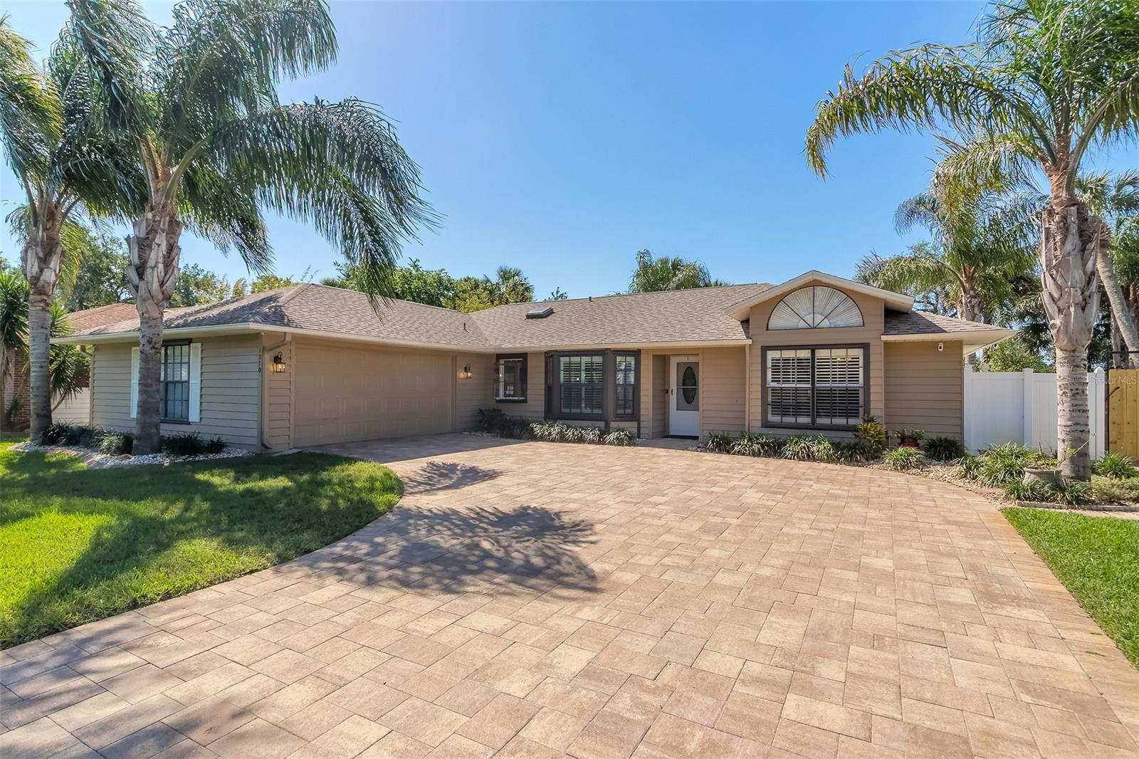 This meticulously maintained 3 bedroom 2 bath home has been completely renovated and is loaded with high end finishes and thoughtful details. It’s perfectly located in the center of New Smyrna Beach, minutes to everything, but located on a quiet neighborhood with no HOA.  As you enter the nearly 2000 square foot home you’ll notice soaring ceilings, warmth from the natural stone travertine floors, and loads of natural light from the skylights above and wall to wall windows in the rear of the home. The beautifully updated kitchen has matching quartz counters and back splash, a stunning quartz sink, custom wood base cabinets with soft close thermos-foil maple grain doors and high end Kenmore Pro stainless appliances. The split bedroom floorplan is perfect for a family or for hosting guests. The Main Bedroom has walk in closet with custom built ins and an ensuite bathroom with double sink and walk in shower. Just off the living room, new French doors open onto the huge under air Florida room and screened in porch that allow you enjoy your private back yard oasis any time of year. The fenced rear yard is loaded with extras to enjoy all summer long, above ground pool, sun pads, shuffle board court and a huge storage building that would make a great man cave or she shed. Additional updates include new sealed paver driveway, professional landscaping, custom planation shutters throughout, pool heating and cooling system, new washer dryer, newer roof, fresh paint the list goes on. Easy to show, call to schedule your showing today! ;Water: City