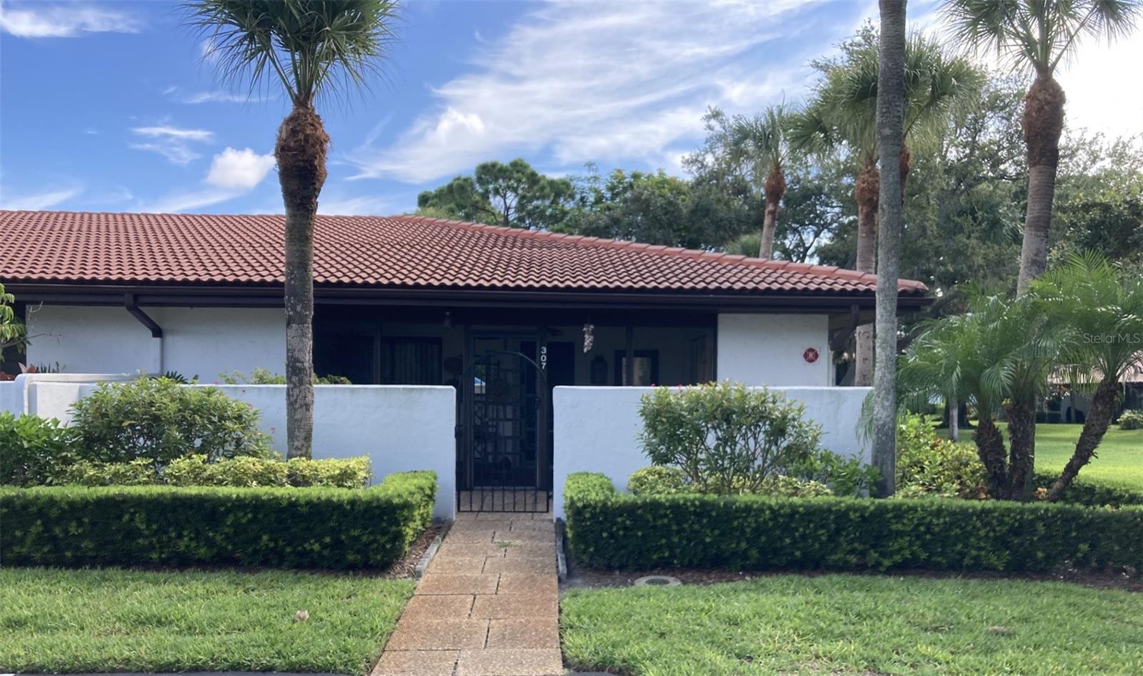 This 1500 square foot sun filled condo is an end unit “villa” with panoramic views on three sides located on a private cul-de-sac off El Conquistador Parkway.  It is single story, one level…no stairs and no neighbors above, which is fully furnished and turnkey ready.  You enter through a gated front courtyard with a large screened lanai and laundry.  The roomy kitchen has a pass-through and plenty of storage. The large living room and dining area lead to a spacious enclosed back lanai, which is air conditioned, that faces the gardens and has direct access to the pool and spa.  Two generous bedrooms each have large walk-in closets and en-suite full baths. There is a covered carport and ample guest parking.  In 2023, the electric panel and water heater were replaced.  The maintenance fee covers cable TV, internet, water/sewer/trash, community pool and spa, landscaping, exterior building and all common area maintenance.  Valencia is a pet friendly community allowing one pet, no weight limit.  

This roomy villa is situated in Valencia Gardens which is in the El Conquistador/IMG Golf and Country Club area.  Bradenton is a peaceful unknown gem along the gulf coast of Florida just south of Tampa, with easy access to all the attractions that Florida has from the Ringling Museum  to Disney World.  It is only a short drive to restaurants, supermarkets, the Bradenton/Sarasota airport and the IMG Academy.  A 15 minute drive west and you are on Anna Maria Island with it’s sandy beaches and beach front dining.  A 25 minute drive south is St. Armand’s Circle in Sarasota for dining, up-scale shopping and cultural attractions.  See why the residents here love to call Valencia Gardens their winter getaway or full time home.