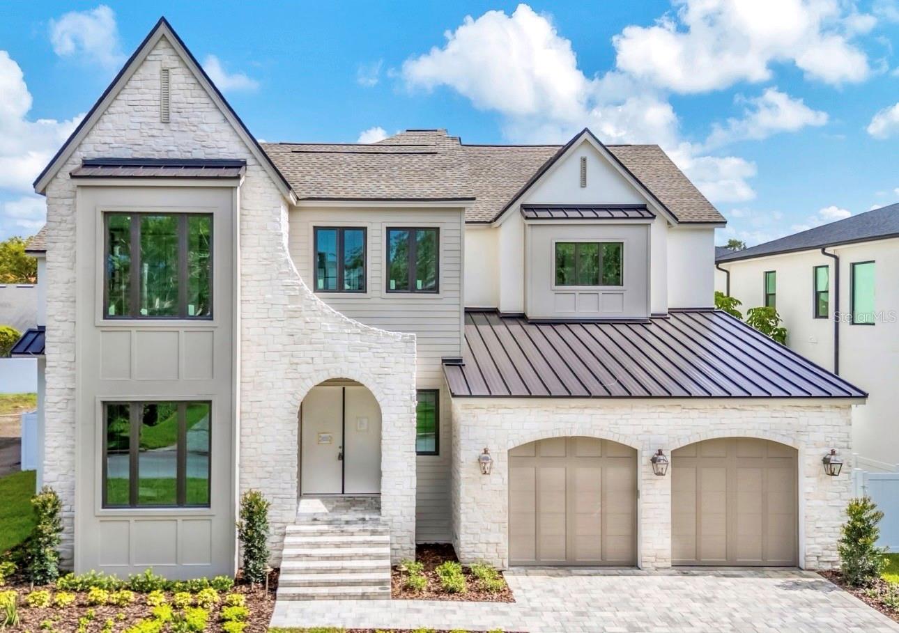 Under Construction. Anticapted early August finish. Experience the pinnacle of South Tampa luxury in this completely custom, never-to-be-replicated modern Tudor estate located just steps from iconic Bayshore Boulevard. Set in highly coveted Bayshore Beautiful, this masterfully designed, nearly 6,000-square-foot residence features 6 bedrooms and 6.5 bathrooms. Built with solid two-story block construction well above the required design flood elevation, the home offers unparalleled peace of mind. Sweeping natural stone architecture and a custom hazelnut brown front door welcome you into a grand two-story foyer. Situated at the front of the house just off the entryway is an executive office enclosed by custom metal and glass double doors. Moving further inside, you’ll notice the custom millwork and a barrel arch drawing you into a thoughtfully designed open-concept floorplan accented by white oak beams and wide-plank wood flooring. The dining room, complete with a beautiful built-in bar, sets the tone for the rest of the property. The chef’s kitchen is a culinary masterpiece featuring premium white oak cabinetry, real Taj Mahal quartzite counters, a professional Wolf range, and integrated Monogram appliances. An expansive scullery with an additional sink, second dishwasher, beverage center, appliance garage, and chilled filtered water filler station makes entertaining effortless while keeping the main living areas immaculate. The main-level primary suite is a private sanctuary featuring an arched tongue & grooved ceiling with a white oak beam, direct lanai access, a spa-inspired bath, and an expansive walk-in closet. Accessible via a beautiful staircase or the convenient in-home elevator, the second floor boasts a spectacular second primary suite, offering the ultimate flexibility to serve as the main owner's retreat or as luxurious multi-generational quarters. This level also features three additional en-suite bedrooms with walk-in closets. Another upstairs living room and a bonus room with an arched ceiling, perfect for a gym, media room or 6th bedroom, complete the upper level. Outdoor living is seamlessly integrated through an expansive covered lanai featuring dedicated living and dining spaces, plus an outdoor kitchen with a grill, sink, beverage center and high-top seating. It overlooks a custom pool, spa, and water feature. A convenient pool bath with a walk-in shower ensures the interior stays pristine. The property is prewired for surround sound, exterior cameras, motorized shades and EV charging. Additionally, all interior walls are soundproofed for maximum privacy. Zoned for South Tampa's premier A-rated schools—Roosevelt Elementary, Coleman Middle, and Plant High School. Perfectly positioned for evening strolls along Bayshore Blvd and just a short walk to the Stovall House and Tampa Yacht Club, this residence offers the ultimate lifestyle. With a targeted completion of early August 2026, a rare window of opportunity remains to add a personal touch to this generational property.