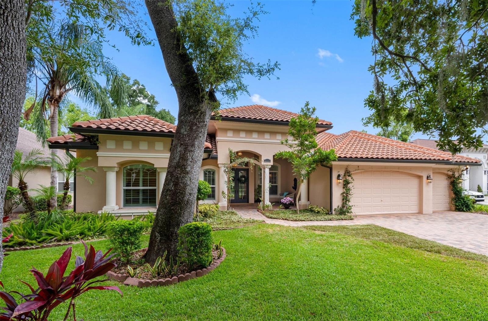 Welcome to this stunning Mediterranean-style residence nestled within the highly sought-after gated community of Carroll Landing, where beautiful tree-lined streets create an inviting neighborhood atmosphere. Offering 3,171 square feet of thoughtfully designed living space, this exceptional home features 4 bedrooms, 3 full bathrooms, a private office, and a spacious 3-car garage. A charming covered front porch with paver flooring welcomes you through elegant double French doors into a bright, open floor plan accented by rich wood flooring throughout the main living areas. The formal living room offers picturesque views of the backyard, while the formal dining room features a convenient pass-through bar to the kitchen, making entertaining effortless. At the heart of the home is a beautifully appointed kitchen featuring 42-inch cherry wood cabinetry with crown molding, granite countertops, stainless steel appliances, a decorative stainless steel range hood, a center island with a prep sink and breakfast bar, and a sunny dinette for casual dining. The kitchen flows seamlessly into the spacious family room, where pocket sliding glass doors open to an oversized screened lanai, creating the perfect indoor-outdoor living experience. Two covered seating areas provide ideal spaces for outdoor dining, grilling, or simply relaxing year-round. Designed with privacy in mind, the desirable triple-split floor plan places the primary suite at the front of the home alongside a private office. The spacious retreat features a spa-inspired bathroom with dual vanities, an oversized walk-in shower, private water closet, and a custom-designed walk-in closet. A private guest suite at the rear of the home offers its own full bath with a walk-in shower, while two additional bedrooms share a well-appointed bathroom with a tub/shower combination. A built-in study nook in the hallway provides the perfect space for homework, studying, or a home workstation. Spacious inside utility at the garage entry. The expansive backyard offers plenty of room for children, pets, or the future addition of a pool or outdoor living space, while the oversized 3-car garage provides abundant storage. Lovingly maintained by its original owners, this home is ready to welcome its next family. Call for your private showing.