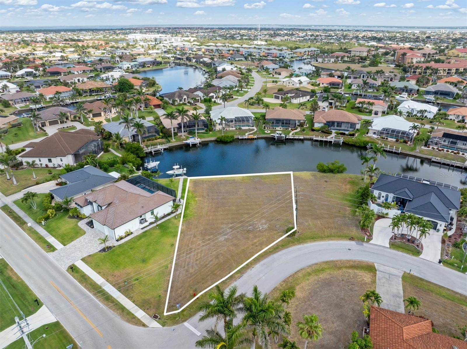 Your next home begins with one decision: where will you keep the boat?
Positioned on a quiet cul-de-sac canal in the sought-after waterfront community of Punta Gorda Isles, this oversized 11,611 square foot sailboat-access homesite offers the opportunity to build a custom home around the lifestyle you've been working toward. With 60 feet of city-owned and maintained concrete seawall, you'll enjoy one of Punta Gorda's most valuable waterfront advantages, eliminating one of the long-term maintenance responsibilities often associated with waterfront ownership.

Keep your boat just steps from your back door and cruise the no-wake canals approximately three miles to Buckley's Pass. Once there, unrestricted boating opens to Alligator Creek, Charlotte Harbor, and the Gulf of Mexico. Spend the morning fishing, enjoy lunch at a waterfront restaurant, explore nearby barrier islands, or simply take an evening sunset cruise. Living on the water means the destination is never far away.

At 11,611 square feet, this larger homesite provides additional flexibility for your home's design, outdoor living areas, pool, and entertaining spaces. The northwest rear exposure creates an inviting setting for relaxing outdoors, while the quiet cul-de-sac canal offers less boat traffic than many interior waterways. Public water, sewer, electric, and fiber are available at the road, making it easy to begin planning your custom home.

Conveniently located just minutes from nearby fuel docks, waterfront dining, Fishermen's Village, historic downtown Punta Gorda, Punta Gorda Airport, and I-75, you'll enjoy easy access whether you're heading out by boat or by car.

With no HOA, no CDD fees, and Punta Gorda Isles now more than 90% built out, opportunities to build a new custom waterfront home continue to become more limited. Whether you're ready to build today, planning for retirement, searching for the ideal second-home location, or investing in one of Southwest Florida's premier boating communities, this exceptional homesite is ready when you are.