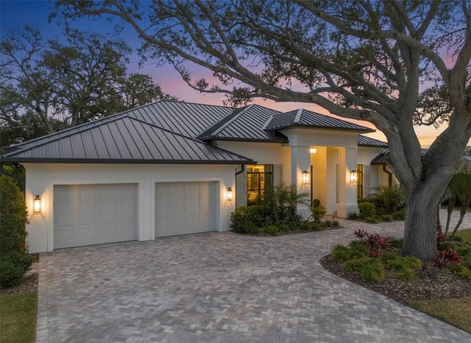 A MUST SEE!!!!! This custom new construction residence overlooking the 5th hole of the Pelican Golf Club. This home offers a rare blend of bespoke craftsmanship, modern luxury, and an exceptional Belleair setting. Thoughtfully designed and expertly built, this home reflects elevated attention to detail and timeless architectural appeal. The interior showcases refined, light-filled living spaces curated for both elegant entertaining and effortless daily living. High-end finishes, custom detailing, and a sophisticated layout underscore the home’s designer pedigree, while expansive windows and sliders frame tranquil golf course views and fill the residence with natural light. No detail has been overlooked in this four to five bedroom, four bathroom home. Enjoy the high ceilings, custom cabinetry and woodwork throughout, Wolfe and Subzero appliances, Waterworks fixtures, and luxury lighting. The standing seam metal roof blends style and energy efficiency, while over 1,000 square feet of air conditioned, finished garage space provides year-round comfortable parking and storage. Outdoor living areas are seamlessly integrated to take full advantage of the lush fairway backdrop with lake views, creating a private, resort-like atmosphere ideal for relaxation or hosting guests. Motorized retractable screens on the porch allow you to bring the outside in when you open the two 16 foot sliders, making the most of the spectacular golf course view.  There is a custom, heated salt water pool and spa, whole home generator, and luxury details like outdoor gas sconces and mature landscaping. Every element of the home has been carefully considered to deliver comfort, style, and enduring quality. Located just minutes from Clearwater Beach, fine dining, boutique shopping, and premier country clubs including the Pelican Golf Club and Belleair Country Club, this exceptional custom-built home presents a rare opportunity to enjoy new construction luxury in one of Florida’s most sought-after coastal golf communities.