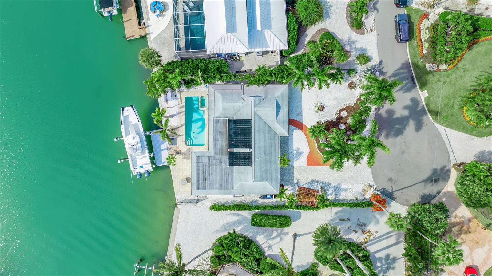 One or more photo(s) has been virtually staged. Vintage Waterfront Cottage on Casey Key. 
Quietly set on Casey Cove Drive, a private cul-de-sac just off Casey Key Road, this refreshed vintage cottage offers exceptional privacy and 180-degree Intracoastal Waterway views across Blackburn Bay. Located within a protected, minimal-wake cove, the setting is serene and timeless—where coastal breezes, open water views, and abundant marine life define everyday living.
Boating is the heart of this property. A brand-new private dock with a 20,000 lb boat lift provides deep sailboat water and generous width to accommodate a large vessel, making spontaneous days on the water effortless. Set along the Intracoastal, the home offers direct access to the bay and Gulf beyond, ideal for boating, cruising, and waterfront exploration.
Refreshed in 2024 and offered unfurnished, the two-bedroom, two-bath residence features luxury vinyl flooring, fresh interior paint, and new KitchenAid appliances. The rear living area opens to sweeping water views, creating a relaxed and inviting coastal atmosphere.
Outdoor living includes a heated pool, in-ground spa, and covered patio overlooking the water—perfect for unwinding as dolphins and manatees pass by. Just a short walk to Nokomis Beach and only one mile from the Albee Bridge, with convenient access to Venice Island, downtown Sarasota, dining, shopping, and the Legacy Trail, this peaceful waterfront cottage delivers a rare boating lifestyle in an outstanding Casey Key location.