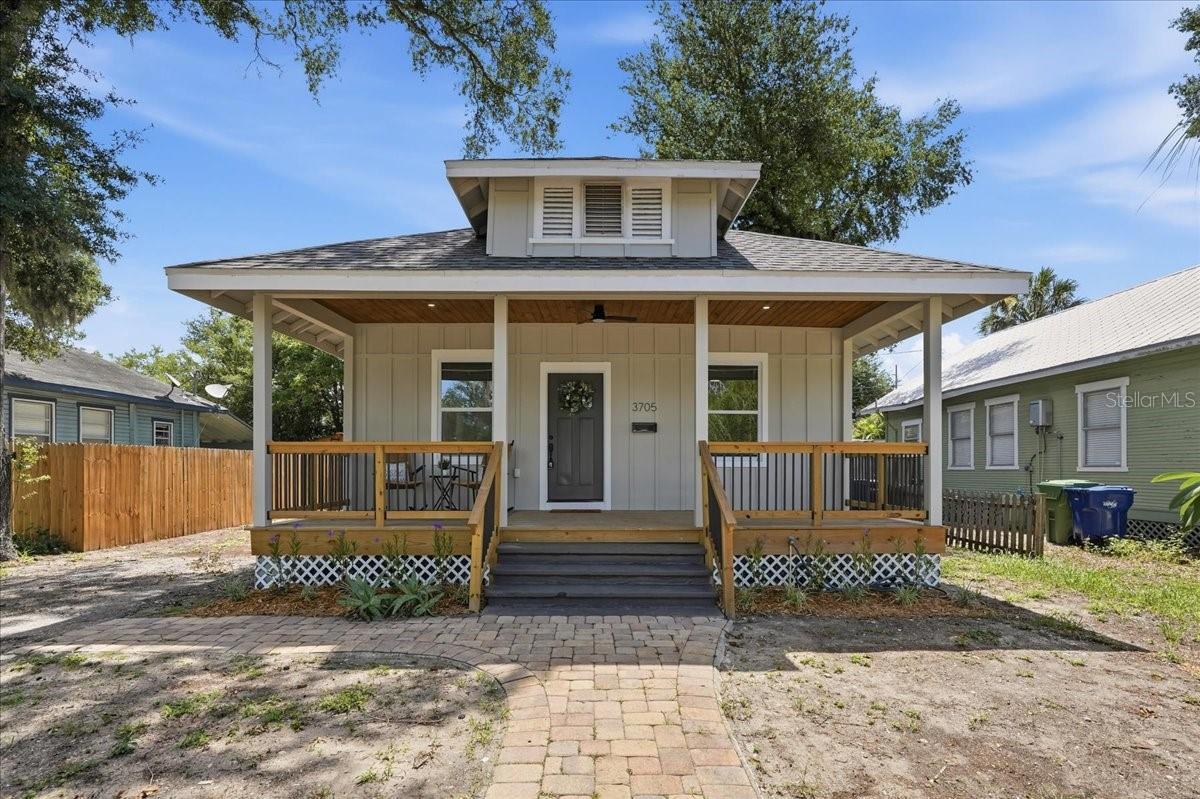 Beautifully remodeled and move-in ready, this charming 1918 bungalow offers timeless character and modern comfort in Arlington Heights. A classic covered front porch, warm wood-plank ceiling and inviting architectural details showcase the charm for which Tampa’s historic homes are known.
Inside, this 3-bedroom, 2-bathroom home offers 1,586 square feet with an open, light-filled layout and raised ceilings. The spacious living room features a sleek built-in fireplace and flows effortlessly into the dining area and beautifully redesigned kitchen—ideal for entertaining. The kitchen showcases quartz countertops, shaker cabinetry, a subway-tile backsplash, stainless steel appliances and a convenient utility closet with backyard access.
The versatile front bedroom offers direct access to a full bathroom that also serves guests and features a tiled tub surround, modern vanity and updated finishes. A second spacious bedroom is located down the hall, while the private primary suite is tucked away at the rear of the home. The primary retreat includes two closets, sliding doors opening to the backyard and a striking ensuite bathroom with a dual vanity, illuminated mirror and floor-to-ceiling tile in the oversized shower.
Thoughtfully restored from top to bottom, the home features a new roof, windows and HVAC, along with upgraded plumbing and electrical. Additional improvements include fresh interior and exterior paint, luxury vinyl plank flooring, new baseboards, trim, doors and lighting throughout.
Outside, the spacious backyard offers excellent flexibility, with convenient alley access, room to create a private fenced retreat and a large storage shed already in place.
Located beside the revitalized Heights district, this home places you just minutes from Armature Works, the Tampa Riverwalk, Downtown Tampa and the celebrated restaurants, breweries and nightlife of Tampa Heights and Seminole Heights. With convenient access to major roadways, nearby parks, entertainment venues and everything central Tampa has available, this is a rare opportunity to enjoy historic neighborhood charm without sacrificing modern comfort or convenience. Welcome home!