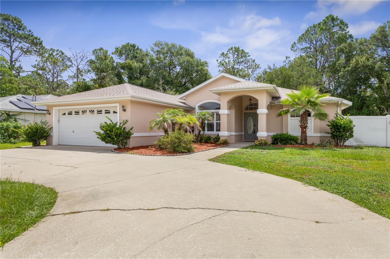 Virtually Staged. Welcome to this beautifully maintained custom-built pool home in the highly desirable Pine Lakes neighborhood, perfectly located in the heart of Palm Coast. This 3-bedroom, 2-bath split floor plan offers the ideal combination of comfort, privacy, and Florida living. Designed for both everyday living and entertaining, the spacious kitchen features white cabinetry, stainless steel appliances, granite countertops, and an open layout that flows seamlessly into the living areas and out to the expansive screened lanai overlooking the sparkling pool. Recent updates provide peace of mind, including a new HVAC system (2024) and a roof replaced in 2019. Throughout the home you'll find durable tile and hardwood laminate flooring—no carpet. Step outside to your own private backyard retreat. A green easement behind the property means no rear neighbors can build behind you, creating a peaceful setting with added privacy. Conveniently located just minutes from shopping, dining, beautiful beaches, golf courses, tennis facilities, parks, and everything Palm Coast has to offer, this exceptional home is ready for its next owner. Don't miss your opportunity to enjoy the Florida lifestyle in one of Palm Coast's most established and sought-after neighborhoods.