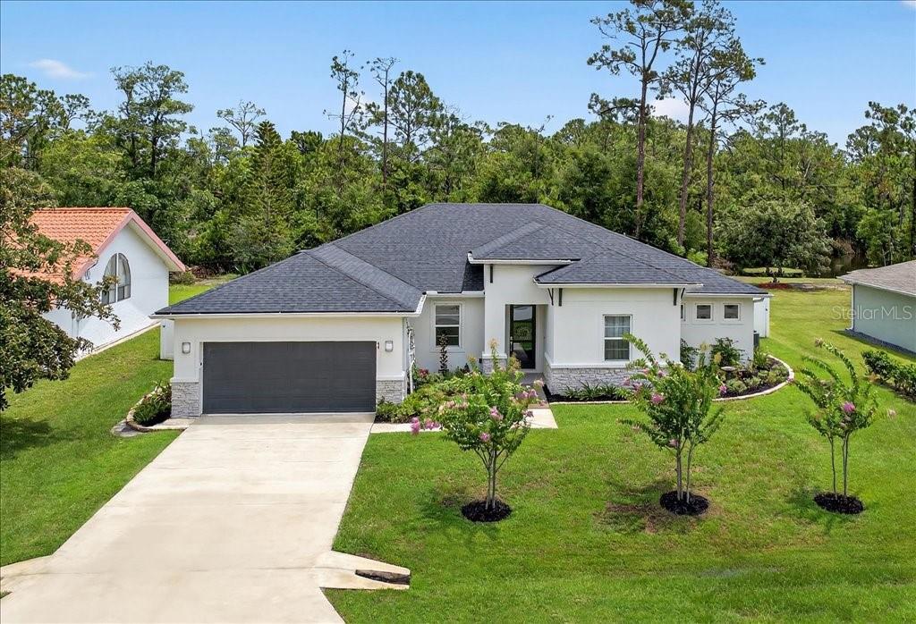 Your forever home awaits in this exquisitely designed, custom luxury oasis. From the moment you step inside, you are welcomed by an open layout featuring elegant porcelain tile floors, automated power blinds, and a private ensuite perfect for guests or multi-generational living. Even the garage is upgraded with custom cabinets and premium vinyl flooring. Culinary adventures await in the chef’s kitchen, beautifully outfitted with a Bosch induction range, powerful 600 CFM hood, and a near-silent dishwasher.
Step outside into a private backyard sanctuary built for ultimate relaxation. Spend sunny afternoons by the heated 30’x14’ saltwater pool with a built-in sundeck, wrapped in gorgeous travertine decking. There is a dedicated hot tub power hookup and a fully finished, insulated 8’x12’ shed with electric. 
This home is intelligently engineered for eco-conscious luxury and a true "net-zero" lifestyle, boasting 30 owned solar panels, a hybrid HVAC, and a hybrid water heater to keep utility bills remarkably low. Complete with smart Z-Wave automation, an Ecobee thermostat, a whole-house water softener, and Rachio irrigation connected to a private well, this property offers next-level efficiency. Enjoy seamless connectivity with two available fiber-optic internet lines. Turnkey perfection!