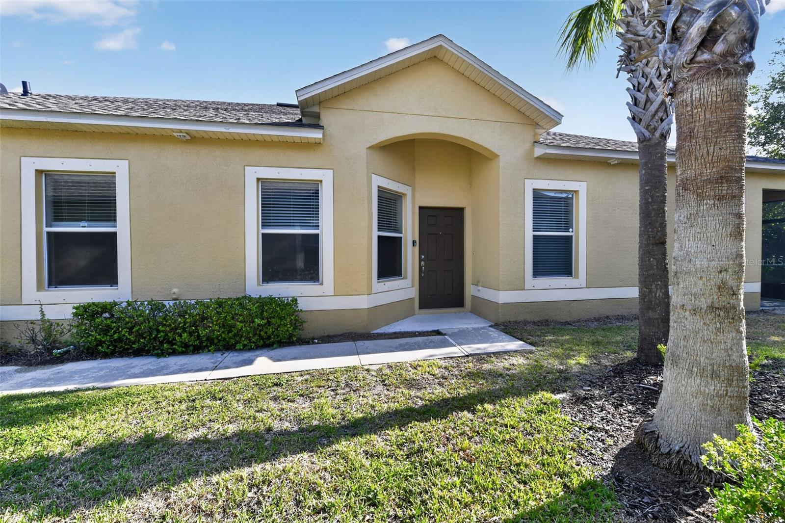 Virtually Staged. Welcome to easy Florida living in the gated Hawks Point community! This spacious, single-story corner townhome offers 3 bedrooms, 2 full baths with an open, split-bedroom floor plan. The kitchen features rich wood cabinetry, granite countertops, stainless-steel appliances, a breakfast bar and abundant storage, opening to the dining and living areas for comfortable everyday living and entertaining. Tile flooring flows through the main living spaces, while attractive plank flooring adds warmth to the bedrooms. The private primary suite includes a generous walk-in closet and an en-suite bath with dual sinks and a walk-in shower. Additional highlights include vaulted ceilings, ceiling fans, indoor laundry, ample closet space and an attached one-car garage. Step outside to the screened lanai and enjoy a peaceful, tree-lined outdoor setting. Hawks Point offers resort-style amenities, including community pools, clubhouses, a fitness center, playgrounds and dog parks. Conveniently located near shopping, dining, major roadways, Tampa Bay attractions and Gulf Coast recreation. Move-in ready!