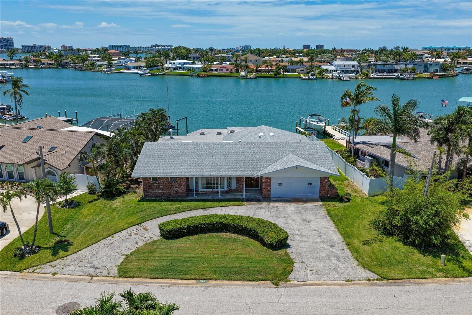 Wake up to beautiful water views and endless possibilities in the highly desirable South Causeway Isle Yacht Club community. Whether you envision restoring the existing residence or creating the custom waterfront home you've always imagined, this remediated 3BR/2BA property offers an exceptional opportunity to own your own piece of paradise. A circular driveway, welcoming front porch, and double entry doors create an inviting first impression, while the prime waterfront setting provides the perfect backdrop for your dream coastal lifestyle. Imagine designing every detail to capture the sparkling water views, refreshing sea breezes, and spectacular sunsets that make this location so special. Surrounded by a friendly boating community and just minutes from shopping, restaurants, entertainment, and the area's award-winning beaches, this property combines an unbeatable location with unlimited potential. Bring your vision, your builder, and your imagination to transform this waterfront gem into the forever home you've always dreamed of in one of the area's most sought-after coastal neighborhoods.