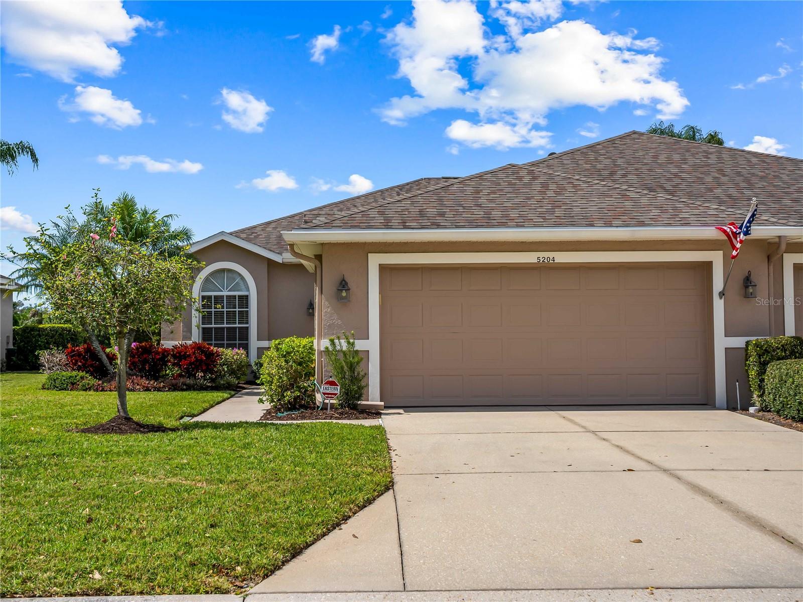 Experience the ultimate maintenance-free lifestyle in this stunning, turnkey Arlington Club home, perfectly positioned as an end unit with beautiful water and golf course views. This residence sits within the community, beautifully surrounded by the certified Audubon Cooperative Sanctuary of Heritage Oaks Golf & County Club. Here, you will live along 500 acres of breathtaking preserves and vibrant wildlife, offering a peaceful lifestyle immersed in nature. The home itself is defined by architectural charm, featuring a versatile third bedroom/den anchored by a bright skylight and elegant diagonal birch flooring. The updated kitchen boast of stainless steel appliances, granite countertops, and a charming breakfast nook, while expansive mirrors in the dining areas enhance the bright, open atmosphere. Both the owner's suite and guest bath have been completely renovated with modern fixtures, custom cabinetry, and granite countertops, including a luxurious walk-in shower in the master suite. Peace of mind comes standard with a fully re-piped and re-plumbed unit. Bask in natural light and iconic Florida sunsets thanks to the home's southern and western exposures. Outdoor living is a dream with a spacious rear lanai overlooking the 12th fairway and a second, south-facing lanai ideal for cooler days.  As part of this golf community, residents enjoy an 18 hole championship course, five heated pools, a fitness center, and four lighted Har-Tru tennis courts. Whether you're grabbing a drink at the 19th Hole Bar & Grill or relaxing at the newly renovated clubhouse, this home offers the perfect upscale lifestyle and the great outdoors.
