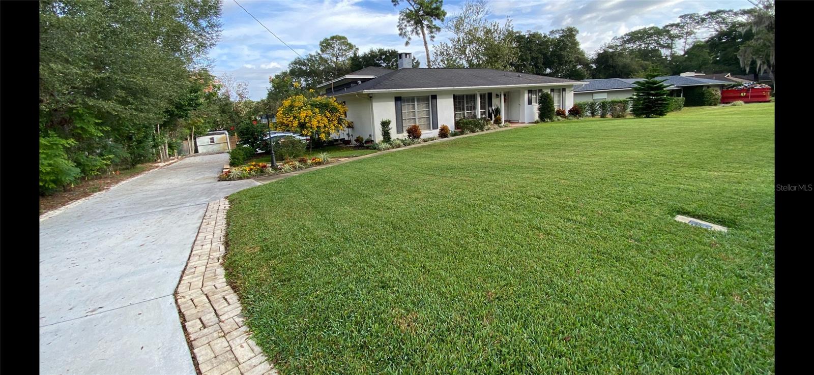 High-Tech Luxury, Smart Security, & Automated Living in Altamonte Springs Experience ultimate peace of mind and modern innovation in this custom, tri-level 3-bedroom, 2-bathroom home with no HOA restrictions. Situated in the heart of Altamonte Springs, this property places you just minutes from the premier shopping, dining, and entertainment at the Altamonte Mall and Crane's Roost Park. Security, connectivity, and utility efficiency are at the core of this property. The home features a comprehensive, enhanced security camera system covering both the interior and exterior for top-tier safety. Perfect for remote workers and tech enthusiasts, the entire property features custom fiber-optic wiring for lightning-fast internet. Management is effortless, as the kitchen appliances, the brand-new water heater (installed in 2025), and even the lawn sprinkler system are fully smart-accessible right from your smartphone. This smart irrigation system runs on a private well dedicated strictly to outdoor watering, keeping your lawn lush while saving heavily on utility costs, while the interior enjoys the reliability of city water and a private septic system. The unique tri-level architectural layout maximizes space and privacy. The main level showcases an impressive kitchen outfitted with timeless solid wood cabinetry and top-tier smart stainless-steel appliances. Main living areas feature durable luxury vinyl plank flooring and a cozy, wood-burning fireplace. The upper level is dedicated entirely to a private primary suite retreat. Big-ticket updates give total peace of mind, including a central A/C system replaced in 2021. The property is currently undergoing professional remodeling updates, with freshly updated flooring in the bedrooms and fully revitalized finishes in both bathrooms scheduled for completion within two weeks—offering the lucky buyer a refreshed, turn-key modern experience! Outside, the property is built for convenience and entertainment. An extended long driveway leads to the garage, providing excellent parking accessibility for multiple cars, work vehicles, or guests. The backyard is fully fenced, offering a private, secure oasis for pets, and weekend gatherings. It also includes a convenient small storage shed out back, perfect for housing your security equipment, tools, and outdoor gear. With its prime location and zero HOA fees, you will enjoy easy access to major highways, making your daily commute simple while keeping local parks right at your fingertips. Heart of Altamonte Springs, minutes from Altamonte Mall & Crane's Roost Park.