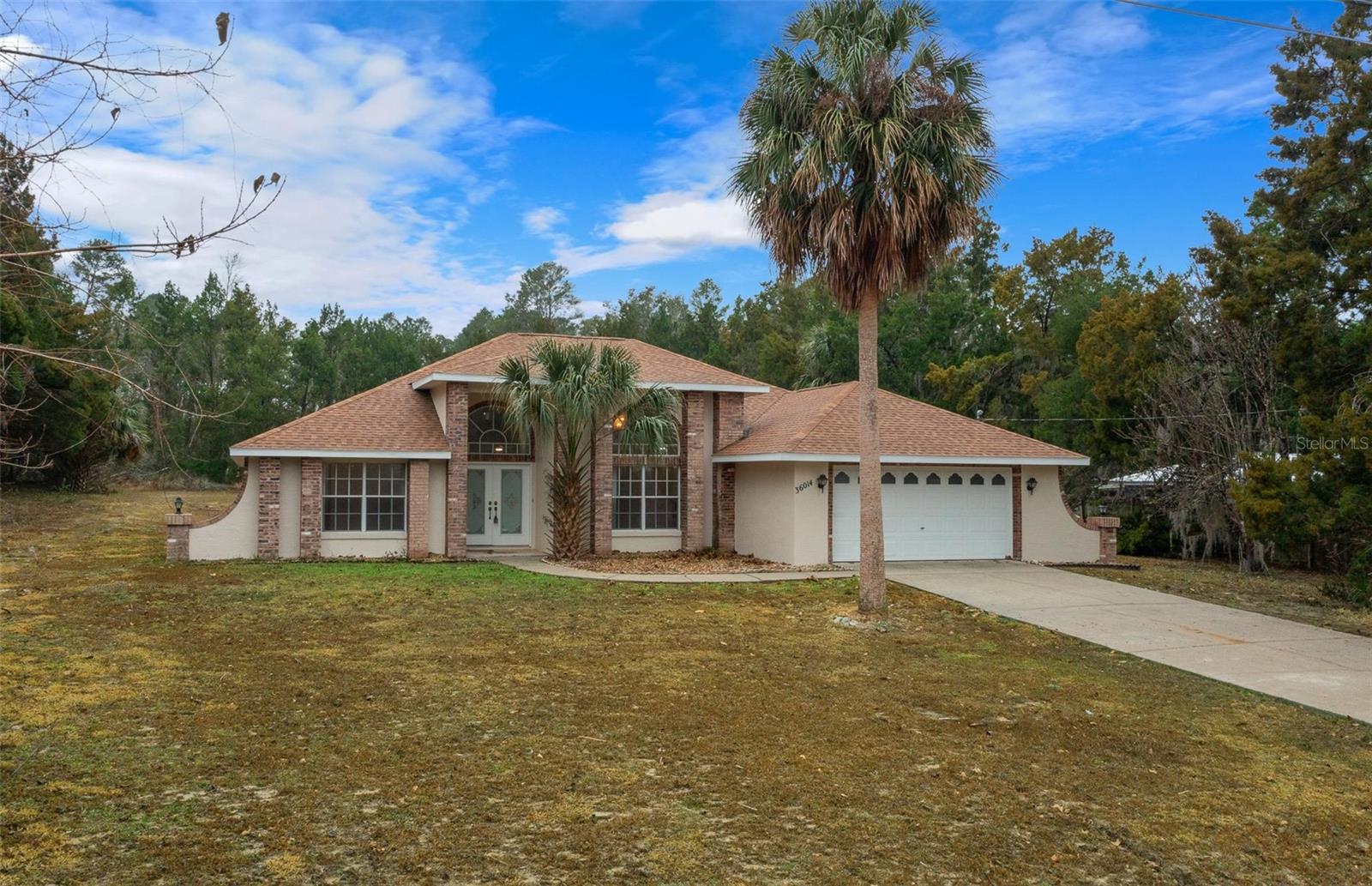 Escape to this beautifully renovated retreat on a private 1.01-acre lot. Offering the rare freedom of no HOA or deed restrictions, this home is a masterclass in low-maintenance living. The interior is light and bright, featuring vaulted skylights in the kitchen and breakfast areas and durable, brand-new waterproof flooring (2025) throughout—no carpet in sight! Nearly every major system has been upgraded for peace of mind, including a new roof (2024), new HVAC (2024), and fresh interior/exterior paint (2025). Step outside to your private oasis: a screened lanai with a cool-deck pool and a cleared, expansive lot ready for your imagination. Located just minutes from The Villages, premier dining, and medical services, this move-in-ready gem offers the perfect balance of seclusion and convenience.