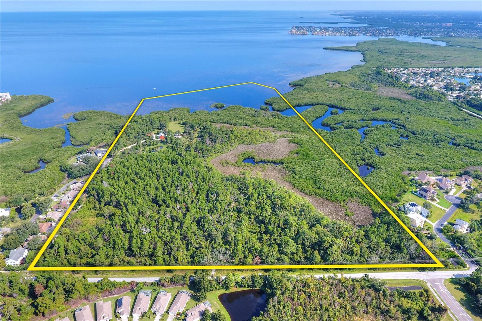 Discover the ultimate lifestyle property with tremendous investment potential. The property features multiple premium conservation lots, thoughtfully designed around a beautiful wetland system that wraps the development area to the east and north, creating a private and scenic natural buffer. Currently zoned for 60 single-family homes, the site offers the potential to rezone for additional homesites, providing excellent flexibility for future development. Ideally situated, the property is just a short walk to Key Vista Nature Park and minutes from US Highway 19, shopping, dining, and everyday conveniences.