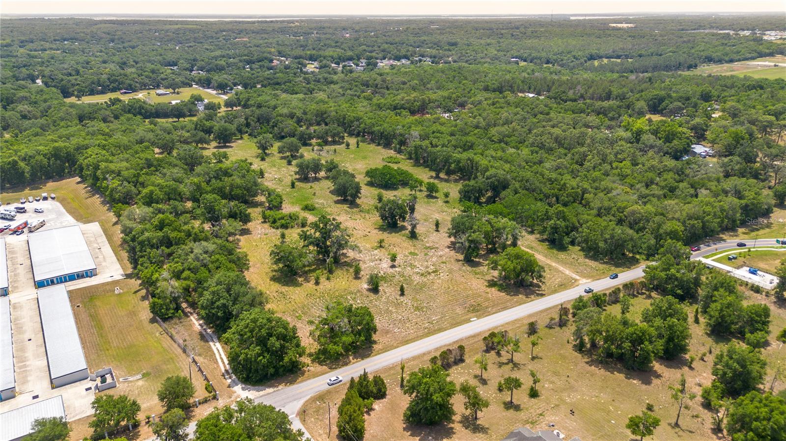 An exceptional development opportunity positioned less than 10 minutes from The Villages®– one of the fastest-growing master-planned communities in the nation. This 18.48 acre parcel carries PUD R-4 Residential Mixed Use zoning and features 639' of road frontage along Rolling Acres Road– offering exceptional access and visibility. Public water and sewer are already on-site. The land itself is mostly cleared and the approved plat is transferable, meaning a buyer can move quickly from acquisition to groundbreaking. Ideal for a multifamily residential project, mixed-use retail/residential development, a townhome community, or assisted living campus. This property is located just across the street from the rapidly growing Hammock Oaks development, which is currently slated to include 724 single-family units, 300 senior living housing, 250 multi-family units, 160,000 sqft of medical space, and 120,000 sqft of retail space. A Walmart Neighborhood Market is also currently being developed in the area. Property comes with an approved preliminary development plan for the Rolling Acres Mixed Use Complex, featuring three development phases with 10 individual building pads, up to ±554,550 sqft of residential potential, ±184,850 sq ft of office/commercial space, up to 12 dwelling units per acre with a maximum building height of 45 feet, a net living area of approximately 1,665 sqft per unit, and 20% dedicated open space totaling ±3.70 acres. This listing is for 3 total parcels, the additional parcel numbers are 20-18-24-1105-000-02200, 20-18-24-1105-000-02101