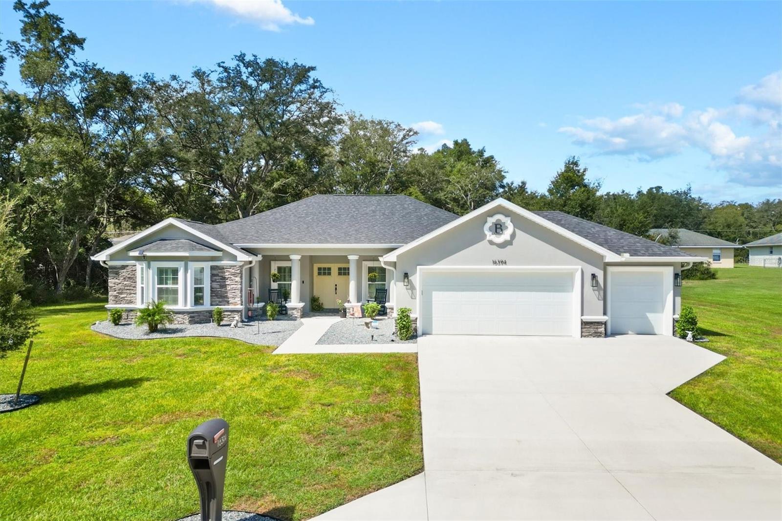 NO HOA NO BOND! Stunning Custom Built 3/3 Designer home with ROOM FOR A LARGE POOL. Across the street to The Villages and Mulberry Publix Plaza, where shopping, dining, and medical facilities await. This open and split floor plan features luxurious West Oak Vinyl Plank flooring, a striking shiplap wall with a 60” linear electric fireplace in the living room, and access to a spacious screened lanai equipped for a hot tub and stone look porcelain floors. This same floor is in the welcoming covered front porch. The Chefs kitchen is complete quartz counters a 5 burner cook top with vented hood and pot filler, built in double oven, built in microwave drawer, walk in custom pantry and island with storage and breakfast bar. The master bedroom features a stylish tray ceiling with crown molding and French doors leading to the lanai, complemented by his and her CUSTOM walk-in closets. The ensuite bath boasts a dual vanity, a glass-enclosed shower with a bench, a soaking garden tub, and a convenient linen closet. The French doors are equipped with inset blinds for added privacy and convenience. The guest bedrooms share a bath with shower. The front bedroom showcases a charming bay window with plantation shutters and a cozy window seat. The back bedroom offers carpeting and private access to a half bath, which also connects to the lanai. The property includes a spacious two-car garage with additional space for a golf cart and loft storage. The interior laundry room is equipped with extra cabinets, a utility sink, and the home's Central WiFi Control Box. Additional features include ceiling fans with light kits, a whole house water filtration system, and a privacy vinyl fence in the backyard that can be expanded for enhanced outdoor living. Electric car charger is included with home. Schedule your appointment today to experience this exceptional home.