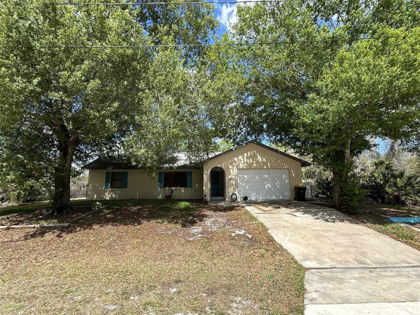 Short Sale. Tucked away in a peaceful rural setting, this 2-bedroom home offers the perfect opportunity to create your own private
retreat. Featuring a desirable split floor plan, the layout provides added privacy and functionality, ideal for both full-time
living or a weekend getaway. Inside, the home offers a bright living space with a natural flow between the living, kitchen,
and dining areas. Each bedroom is positioned on opposite sides of the home, making it comfortable for guests or shared
living. A standout feature is the air-conditioned lanai, lined with windows that invite in natural light and allow you to enjoy
the surrounding landscape year-round—an ideal spot for relaxing, reading, or entertaining. Set on a spacious lot, the
property offers a large yard with plenty of room for outdoor activities, gardening, or simply enjoying the quiet, rural
surroundings. This home is being sold as-is and does need some TLC, making it a great opportunity for buyers looking to
add their own personal touch or invest in a peaceful property with potential.
