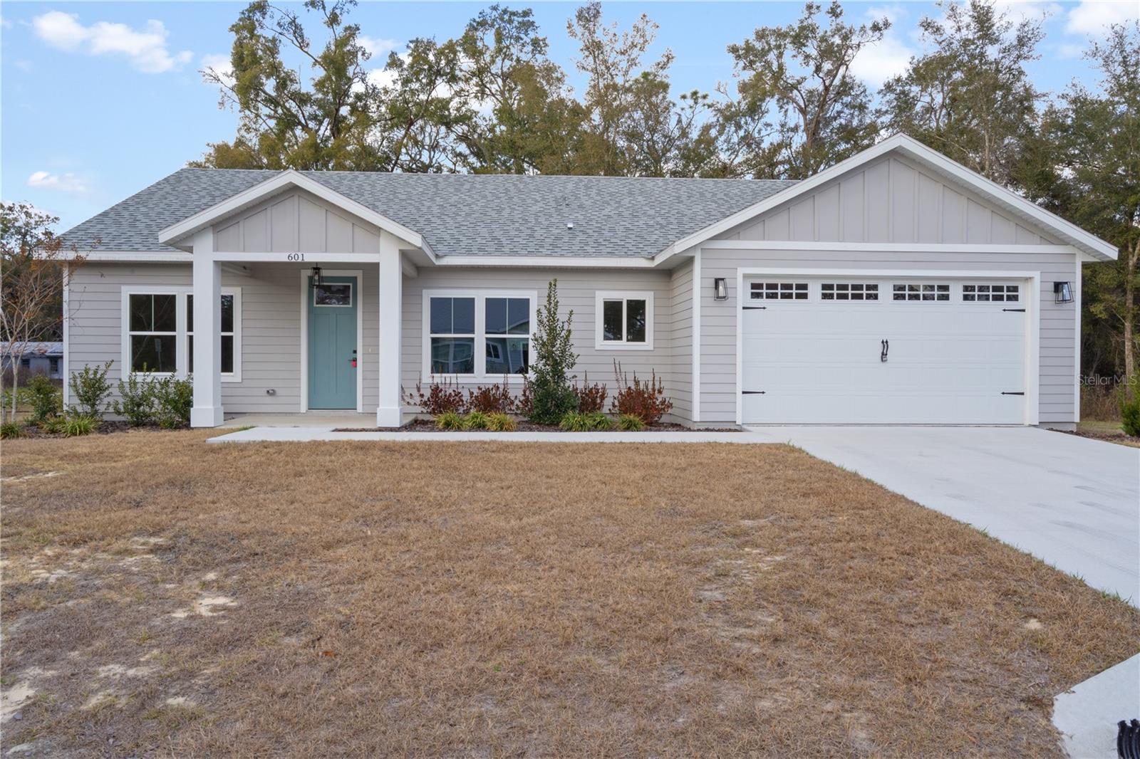 Be one of the first to own in the new community of Aloma Estates offering this brand new 3 bedroom, 2 bath home located on a spacious half acre lot with up to $15,000 being offered toward closing costs and prepaids. This home features an open layout with a split floor plan, tile flooring with a wood plank look throughout, and a low-maintenance hardie board /cement exterior siding. The kitchen includes a large island, quartz countertops, and wood cabinetry, creating a functional space for daily living and gatherings. The primary suite includes a tiled shower with bench, private toilet room, and a walk-in closet. Additional features include a dedicated laundry room, mudroom, 2-car garage, covered front porch, covered back porch and spacious backyard. The property is close to schools and offers an easy commute to Gainesville. 100% financing available to those who qualify. or message today to schedule your private showing and learn how to make this home yours.