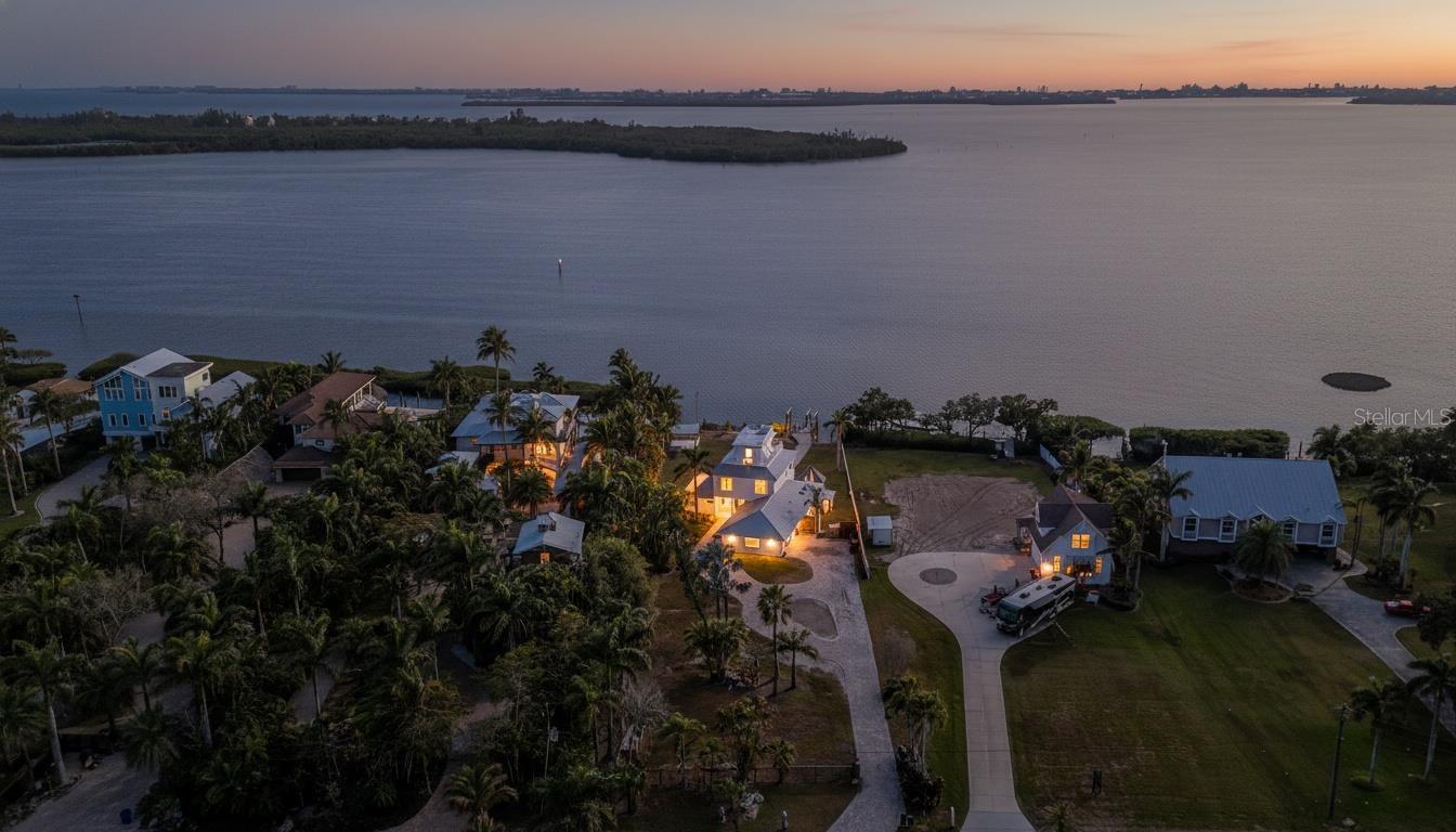 PRICE IMPROVEMENT!! Wide, open water views and exceptional outdoor living define this rare DEEP SAILBOAT waterfront opportunity. Set on more than 3/4 ACRE directly on Sarasota Bay, the property offers 106 feet of frontage with sweeping, unobstructed vistas that stretch across the water and capture the beauty of Florida’s Gulf Coast. Tucked along a peaceful residential waterway, the setting provides a sense of privacy while still offering direct boating access to both the bay and the Gulf of Mexico, making it ideal for those who enjoy life on the water.
The 2,537-square-foot block home includes four bedrooms and two renovated bathrooms, with thoughtfully positioned living spaces that take full advantage of the surrounding views. Nearly every room enjoys a connection to the outdoors, creating a light-filled and inviting atmosphere throughout. Mostly rebuilt in the late 1990s, the home offers a solid foundation with generous interior proportions, making it well-suited for modern updates or a complete reimagining. The recently renovated kitchen features custom cabinetry, quartz surfaces and high-end appliances, blending contemporary finishes with everyday functionality. The living room has a sleek decorative electric fireplace with shimmering glass pieces that is seamlessly inset into the wall, creating a clean, modern focal point that enhances the living space.
Outdoor living is a standout feature of the property, with balconies that overlook the water and provide ideal spaces for relaxing or entertaining. A rare rooftop terrace elevates the experience even further, delivering panoramic coastal views and unforgettable sunsets. The expansive lot offers ample room to enhance the existing residence or design a custom waterfront retreat tailored to your vision.
Located in West Bradenton, the property combines a quiet neighborhood setting with close proximity to some of the area’s most desirable coastal destinations, including Anna Maria Island and Longboat Key. Whether enjoyed as it is or transformed into a custom designed waterfront estate, this property represents a unique opportunity to own a piece of Sarasota Bay with endless potential.