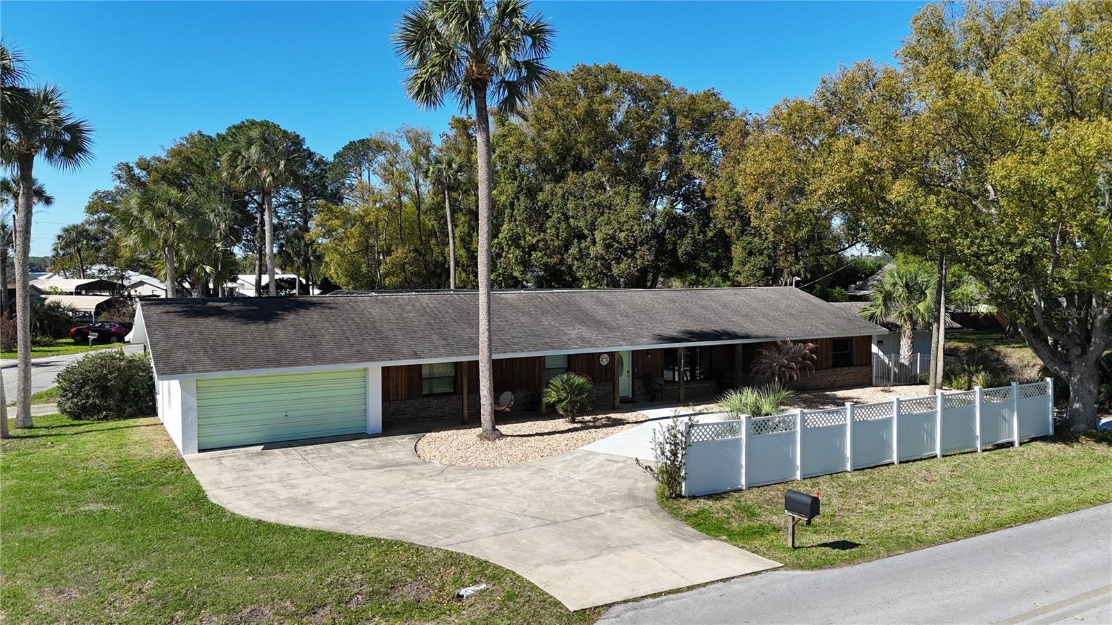 THIS BEAUTIFULLY UPDATED HOME IS PRICED AT ALMOST $100,000 LESS THAN THE 2026 APPRAISED VALUE.  THIS SIGNIFICANT INCREASE UNDERSCORES THE EXCEPTIONAL VALUE OF THIS PROPERTY.  THIS PRESENTS A FANTASTIC OPPORTUNITY FOR THE BUYER, AS THEY WOULD HAVE THE POTENTIAL FOR IMMEDIATE EQUITY AT THE TIME OF PURCHASE. 
DON'T MISS OUT ON THIS INCREDIBLE VALUE! With a full price offer, the owner will include a 2022 Seadoo Switch boat.   This charming home offers the perfect blend of comfort, style, and waterfront lifestyle. Designed with entertainment in mind, the home features multiple indoor and outdoor gathering spaces that flow seamlessly together. Step inside to find a light-filled interior with sliding glass doors that open to a spacious bar area—perfect for hosting guests. A second set of sliding doors leads you to the stunning outdoor retreat, complete with a sparkling pool, relaxing jacuzzi, and elegant travertine decking, creating a true private oasis. The home also boasts a generous bonus room with an additional built-in bar, offering endless flexibility as a game room, entertainment lounge, home gym, or whatever suits your lifestyle. Situated on two lots, this property provides added space, privacy, and future potential. Enjoy direct access to the water with your own boathouse and canal frontage leading out to Lake Weir—ideal for boating, fishing, or simply enjoying Florida’s natural beauty. This is a rare opportunity to own a move-in-ready waterfront home designed for both relaxation and entertaining.