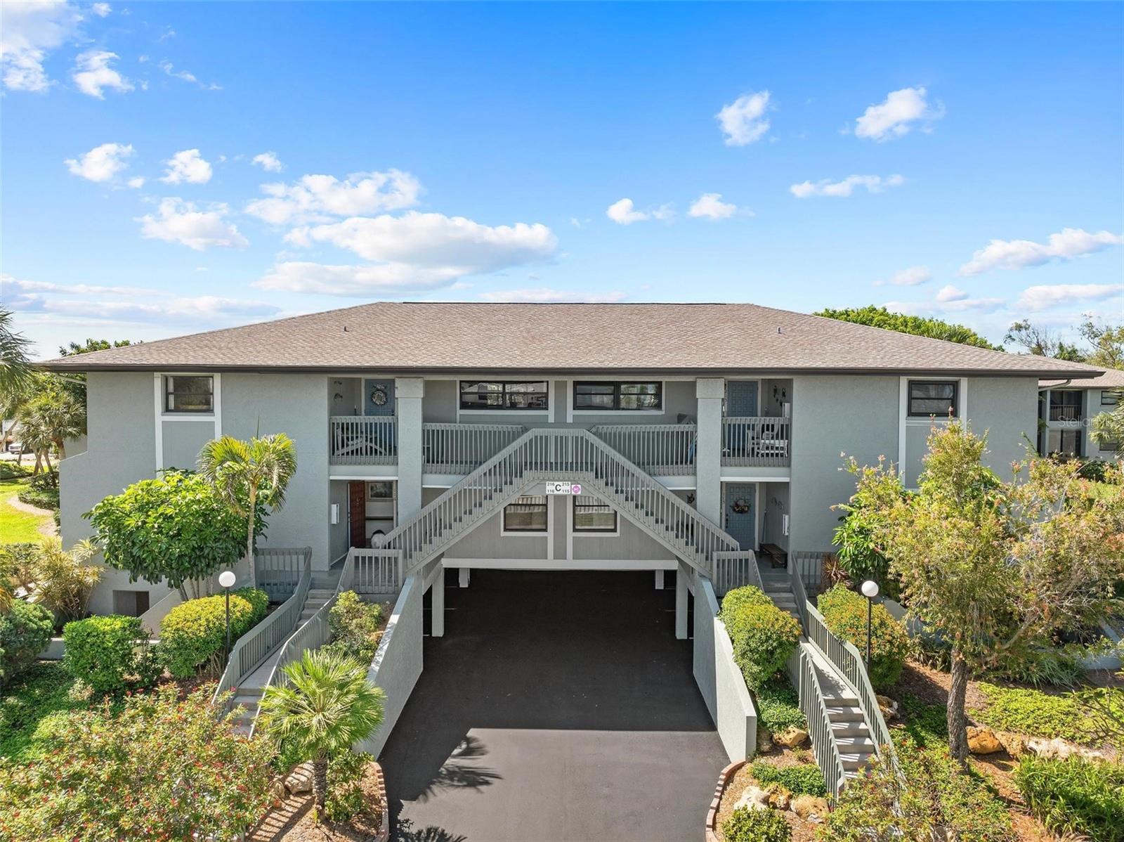Virtually Staged. Virtually Staged. NEW ROOF installed in 2025! Welcome to this freshly remodeled, elevated 2-bedroom, 2-bathroom end-unit condo with a flex room at Island Village in Holmes Beach. Perfectly located just one block from the pristine sands of Anna Maria Island. This bright and airy condo has been thoughtfully updated, featuring a clean, modern aesthetic. It includes two dedicated parking spaces under building and includes a storage room. The interior has been freshly painted and new tile floors installed in the kitchen and flex room. One of the standout upgrades is the enclosed flex room, now fully under air with the recent extension of the A/C system. This versatile bonus room serves as a wonderful flex space, featuring a large closet and offering endless possibilities for use. Use it as a bright and inviting sunroom filled with natural light, a comfortable home office that inspires productivity, or a cozy retreat that effortlessly adapts to your lifestyle needs. This sun-filled retreat is enhanced with sliding glass doors and Phifer weave sunscreen shades, offering views of the lush, park-like surroundings. The kitchen is designed with both style and functionality in mind, featuring durable Corian countertops, a breakfast bar, a Whirlpool full-size stainless-steel refrigerator and freezer, and custom Kitchen Craftmade Cabinetry. The primary bedroom includes sliding glass doors that open to the air-conditioned flex room, a large walk-in closet, and an en-suite bathroom with a walk-in shower. The second bedroom offers another ensuite bath, making it ideal for guests or family members. A dedicated laundry room with a full-size washer and dryer adds everyday convenience. Recent updates include a NEW ROOF in 2025, an upgraded electric meter in 2024, and refreshed exterior paint completed in 2021. The condo also includes an osmosis water filtration system. This condo is part of Island Village condominiums, a well-maintained, maintenance-free community where the HOA covers cable TV, internet, water, sewer, trash, insurance, and upkeep of the grounds, exterior, community pools, and tennis courts. Residents enjoy access to two heated pools and two tennis/pickleball courts, offering ample recreational opportunities year-round, and owners are permitted to rent their condo up to three times yearly, with a minimum rental period of one month. Located only two blocks to direct beach access, this condo is ideally positioned within easy access to over 20 public beach access points, 12 parks, popular restaurants, and local shops. Don’t miss this rare opportunity to own a beautifully updated condo in one of Anna Maria Island’s most desirable communities. Schedule your tour today and experience the relaxed, tropical lifestyle of Island Village. Be sure and check out the 3D walkthrough and floor plan for this lovely condo in Island Village.