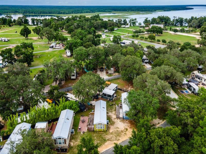 Charming Retreat Near the Ocala National Forest – 15991 NE 243 Place Rd Unit 31, Fort McCoy, FL 32134 Offered at $120,000 | 1 Bed | 1 Bath | 492 Sq Ft Discover peaceful, low-maintenance living in this inviting 2006 mobile home located in the scenic KOA Oklawaha Campground. Whether you're looking for a full-time residence, seasonal getaway, or a short-term rental investment, Unit 31 offers comfort, value, and access to endless outdoor recreation. This 492 sq ft home features 1 bedroom, 1 three-fixture bathroom, an open-concept living area, built-in kitchen, and a spacious wood deck perfect for outdoor relaxation. Recent Upgrades & Maintenance (High-Value Improvements): - New roof, floors and siding (2024) - HVAC system repaired (2024) - Shower leak professionally repaired (March 2025) - Additional ground strapping installed (county code prior to current ownership), adding extra stability and safety Community Amenities: Enjoy resort-style amenities in the KOA campground including: - Swimming pool, clubhouse, and dog park - Playground, volleyball, corn hole, and beach area - ATV riding trails and scenic nature paths leading to a lake overlook Family-friendly atmosphere with activities for all ages Prime Location: - Minutes from downtown Fort McCoy: grocery store, doctor, pharmacy, gas, hardware, and pizza delivery - 30 miles to Ocala for additional shopping, dining, and medical care Near lakes, springs, and Ocala National Forest for fishing, hunting, hiking, boating, kayaking, and ATVing ?? HOA includes electric, water, sewer, trash, and full access to amenities. Whether you're looking to relax, explore, or invest, Unit 31 is a rare opportunity to own an updated, move-in-ready home in one of Central Florida’s most active outdoor communities. Schedule your private showing today!