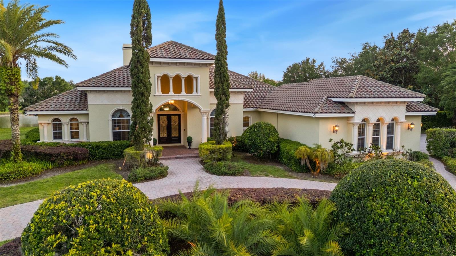 Welcome to an extraordinary expression of timeless luxury and refined living in the exclusive, gated enclave of Northbridge at Lake Pretty—one of Odessa’s most coveted communities. Set on just under one acre of pristine, water-frontage property, this stunning estate at 7906 Foxcatcher Court offers nearly 5,000 square feet of impeccably designed living space, where elegance meets comfort in every detail. From the moment you enter, you are greeted by soaring ceilings, grand living spaces, and rich architectural character. The formal living room serves as a true showpiece, anchored by a striking stone wood-burning fireplace, creating an inviting yet sophisticated atmosphere. A formal dining room just off the kitchen sets the stage for unforgettable dinner parties and holiday gatherings. At the heart of the home is a true chef’s kitchen, thoughtfully designed for both function and beauty. Featuring an oversized center island, Thermador cooktop, built-in KitchenAid Professional Series refrigerator, and double ovens, this space is perfectly suited for everything from casual mornings to curated holiday meals. The home offers 5 spacious bedrooms, 3 full baths, and 1 half bath, with warm wood flooring in all bedrooms and travertine throughout the main living areas, blending luxury with comfort. A versatile bonus room provides the ideal setting for entertaining—perfect for a billiards lounge, game room, or gathering space. Designed for both relaxation and entertainment, the home also features a private movie theater, elevating your at-home experience. Step outside to your personal retreat, complete with a resort-style pool and outdoor kitchen, all overlooking serene water views—an ideal backdrop for entertaining or unwinding in total privacy. Car enthusiasts and fitness lovers will appreciate the air-conditioned 3-car garage, currently outfitted as a full home gym, offering flexibility to suit your lifestyle. This is more than a home—it is a statement of elegance, privacy, and elevated living in one of Odessa’s most desirable gated communities. Schedule your private tour today and experience the exceptional lifestyle that awaits.