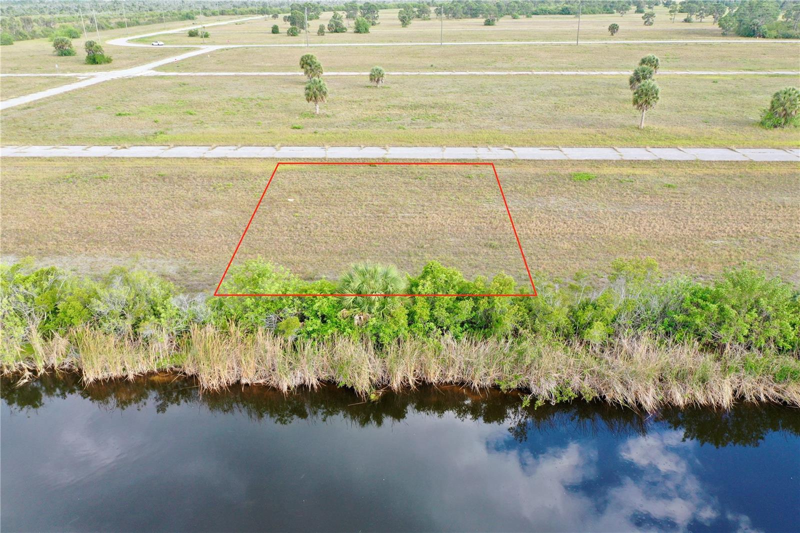 Experience the quintessential Florida lifestyle with this prime 7,500-square-foot building lot situated on a tranquil freshwater canal in the peaceful community of Rotonda Meadows & Villas. This 75x100 foot property offers a serene waterfront backdrop for your future home, where you can enjoy morning coffee overlooking the canal or spend afternoons kayaking right from your backyard. Unlike many rural Florida homesites, this property provides the modern convenience and peace of mind of having public water and sewer services already available for connection. It is located within a well-maintained, deed-restricted community that ensures high neighborhood standards while maintaining remarkably low annual HOA fees, making it an ideal choice for a primary residence or a seasonal retreat. The location is a dream for those who value both accessibility and leisure, situated approximately 25 minutes from I-75 for effortless travel north to Sarasota and Tampa or south toward Fort Myers and Naples. Outdoor enthusiasts will find themselves in a true paradise, as the property is just a short drive from the world-class beaches and turquoise waters of Boca Grande and Englewood. For the avid golfer, the area is surrounded by an incredible density of courses, including the five championship courses of the Rotonda Golf & Country Club and several other nearby public links. Boaters and anglers will also benefit from the proximity to multiple public boat ramps, offering quick and easy access to the legendary fishing and expansive waters of Charlotte Harbor and the Gulf of Mexico. This lot represents a rare opportunity to secure a piece of the Florida dream in a community that perfectly balances natural beauty with modern amenities and convenience.