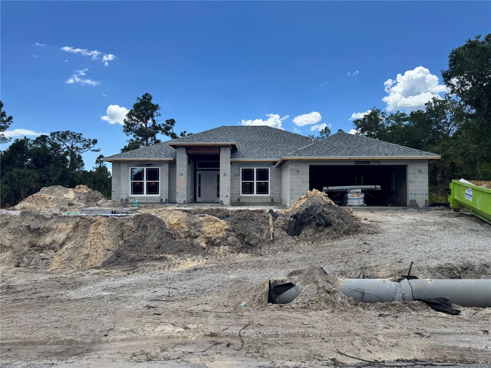 Under Construction. Step into the impressive Adams Homes 2330 model, a spacious 3-bedroom, 2-bath home offering 2,330 sq. ft. of living space designed with comfort and style in mind. This open-concept floor plan features a large great room, formal dining area, and a flexible den perfect for a home office or guest space. The modern kitchen showcases granite counter tops, stainless steel appliances, and a generous breakfast bar overlooking the family room — ideal for entertaining and everyday living. The owner’s suite provides a peaceful retreat with a tray ceiling, walk-in closets, and a private en suite bath featuring dual vanities and elegant finishes. This home also includes a 2-car garage, tile flooring in main areas, and carpet in bedrooms for added comfort. Located in a quiet area of North Port close to shopping, dining, parks, and Gulf Coast beaches, this home combines style, space, and value. Builder pays most closing costs with preferred lender!